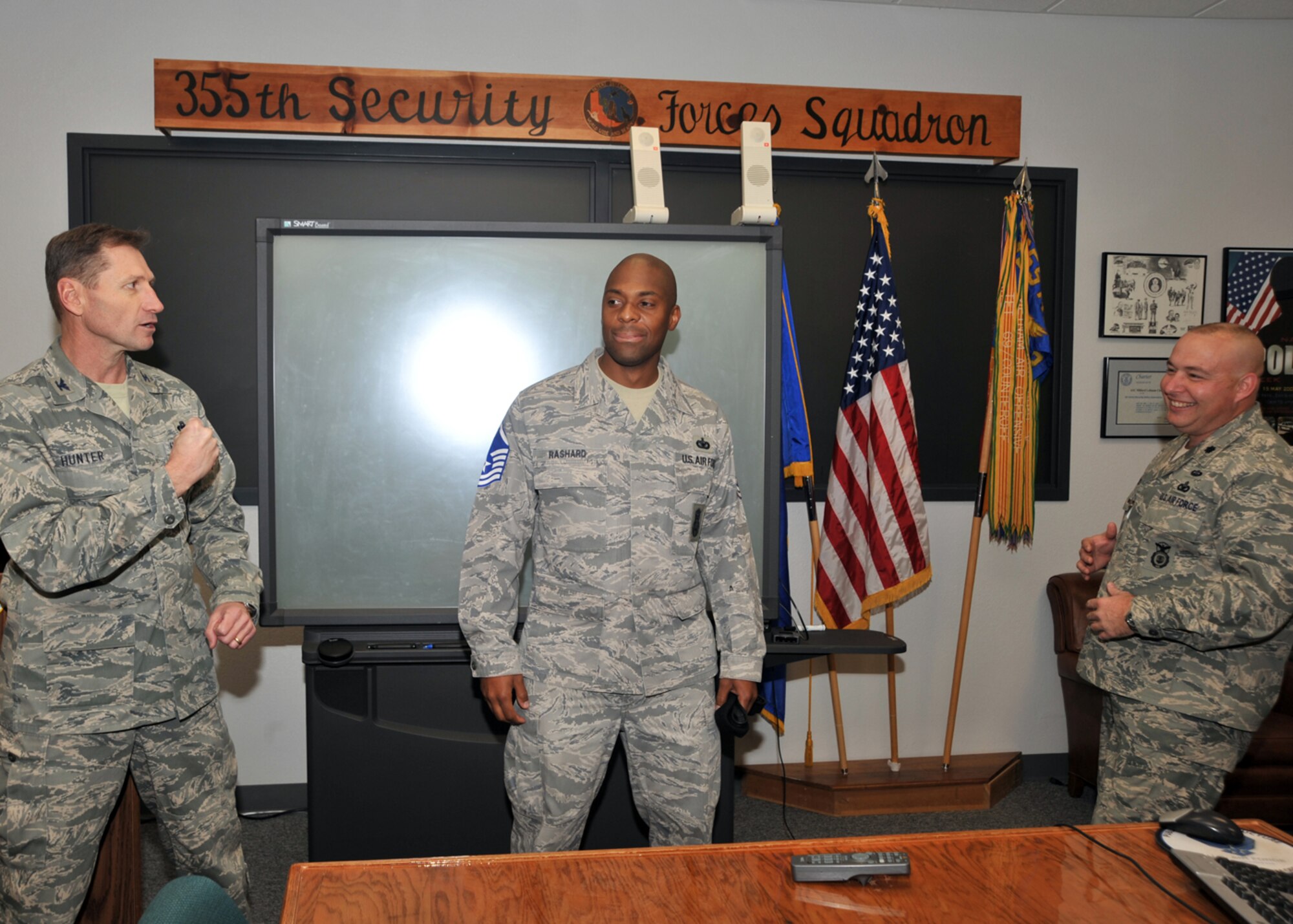 Davis-Monthan Air Force Base; Ariz. -- Col. Charles Hunter, 355th Mission Support Group commander, and Lt. Col. James Hodges, 355th Security Forces Squadron commander, pin Master Sgt. stripes on STEP promotee Master Sgt. Ahmad Rashard, 355th Security Forces Squadron, here, Dec. 24. Sergeant Rashard is one of four D-M Airmen selected for promotion under the Stripes for Exceptional Performers Program. (U.S. Air Force photo/Master Sgt. Heather Cabral)