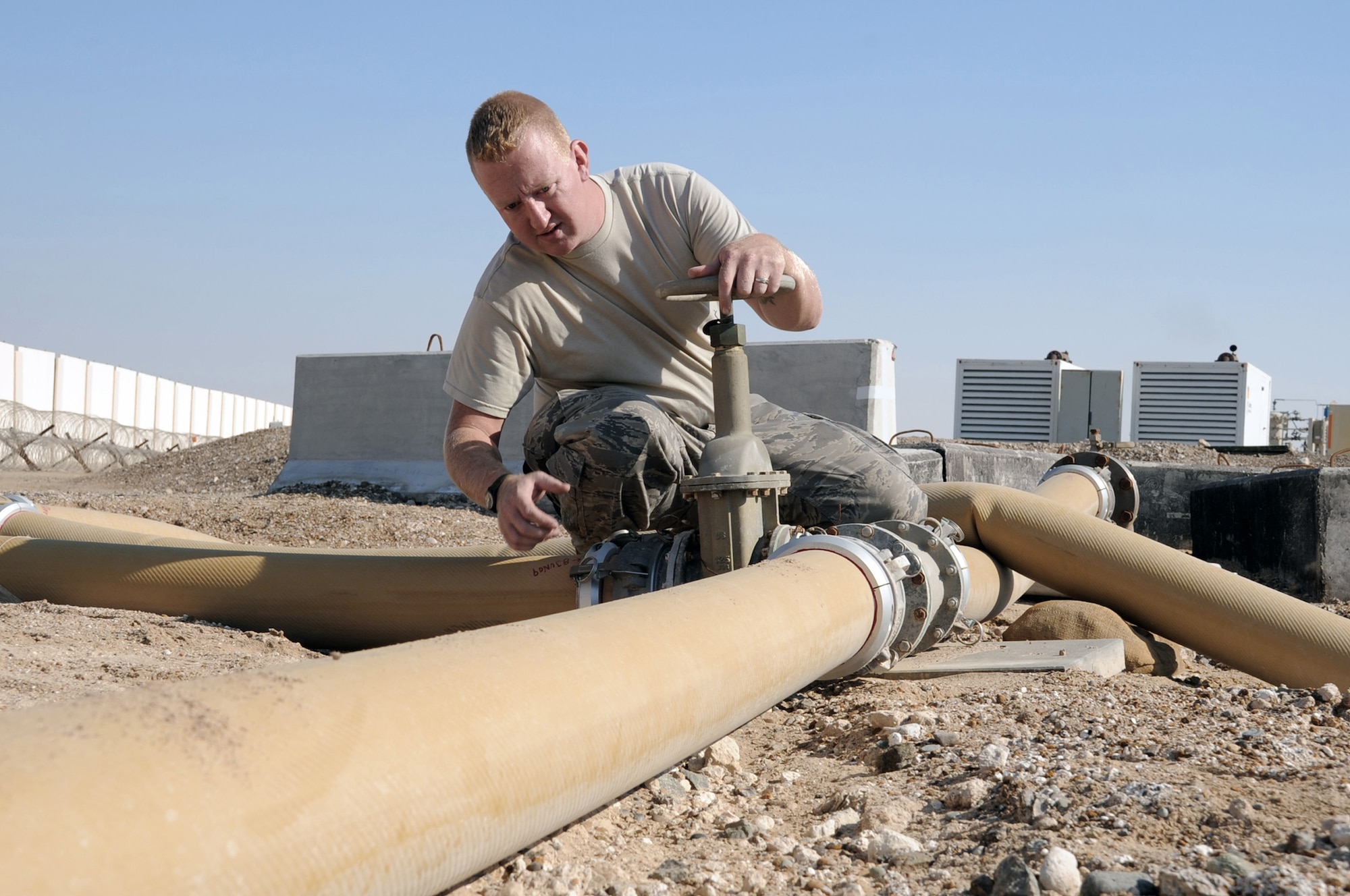 Staff Sgt. Garret Nichols checks a fuel pipeline connection during operations at the fuel bladder storage facility at a base in Southwest Asia Jan. 6, 2010. Sergeant Nichols is a fuels distribution craftsman with the 380th Expeditionary Logistics Readiness Squadron fuels management flight. (U.S. Air Force hoto/Tech. Sgt. Scott T. Sturkol)