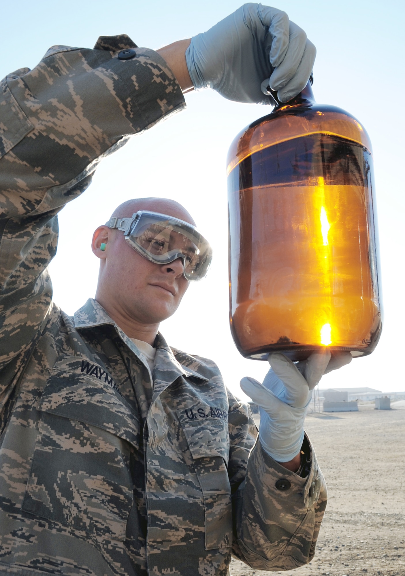 Staff Sgt. Craig Wayman checks a sample of fuel from a fuels truck during operations at a base in Southwest Asia Jan. 6, 2010. Sergeant Wayman is a fuels laboratory technician with the 380th Expeditionary Logistics Readiness Squadron.. (U.S. Air Force photo/Tech. Sgt. Scott T. Sturkol)