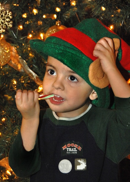 Nicholas Brunson takes a candy cane break during the Travis Fisher House 8th Annual Tree Festival on 4 December 2009. 
 The Travis Air Force Base Fisher House is one of more than 30 homes built on military installations by the late Zachary and Elizabeth Fisher. They generously created a foundation to help military families in need where they can stay without charge when one of their members is hospitalized. 
 This year, the auction raised approximately $2,700 for the Travis Fisher House.   (U.S. Air Force photo by Civ/Nan Wylie)