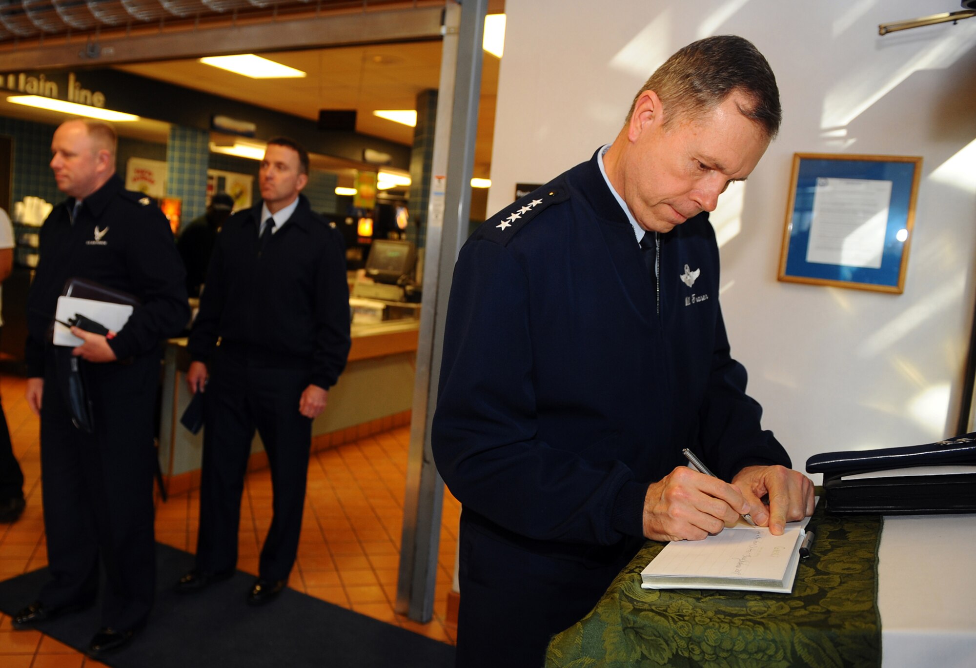 OFFUTT AIR FORCE BASE, Neb. -- Gen. William M. Fraser III, commander of Air Combat Command, signs the guest book at the Ronald L. King Dining Facility here following lunch as part of a one day tour of Offutt Jan. 11. During General Fraser's visit, he provided opening remarks at the annual ACC Chief's Orientation at the Dougherty Conference Center, toured numerous facilities including 55th Wing headquarters and the Patriot Club, and held an all call at Dock 1 of the Bennie Davis Maintenance Facility where he shared his vision with Team Offutt. U.S. Air Force Photo by Josh Plueger
