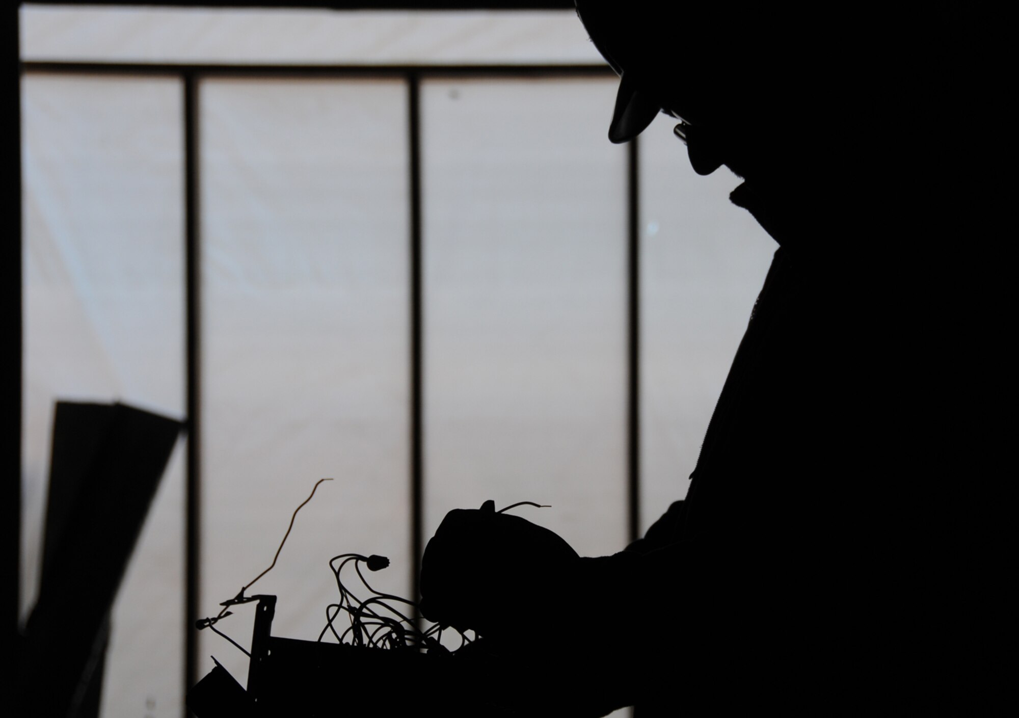 Todd Kinderman from Edwards Electric works on wiring at the event center.  Contractors are working above the ceilings installing electrical wiring, ductwork and plumbing lines.  (U.S. Air Force photo by Kemberly Groue)