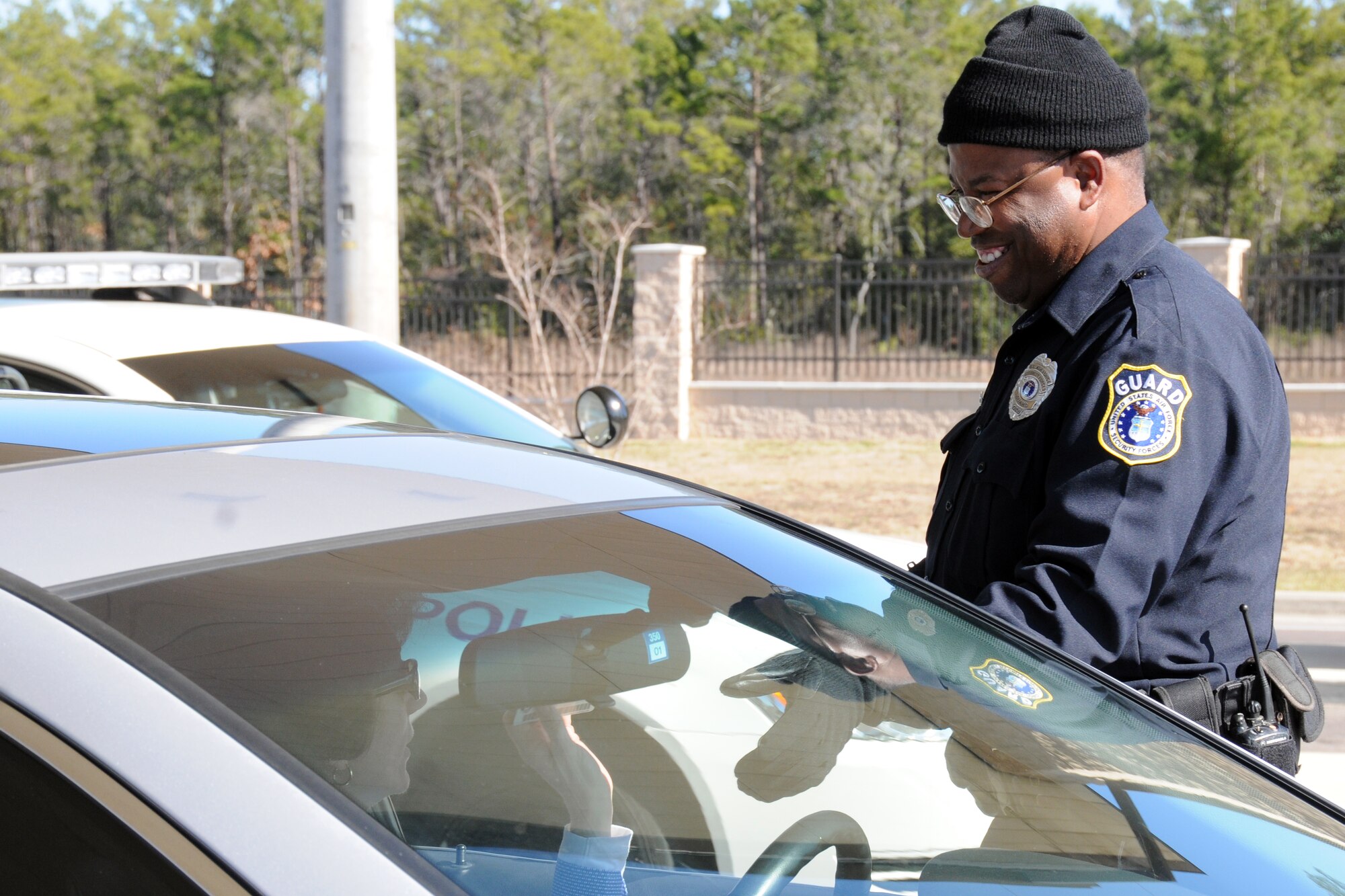 EGLIN AIR FORCE BASE, Fla. -- Banks Jones checks IDs at the East Gate Jan. 12, here. New manpower increases have helped alleviate slow downs and congestion during peak periods throughout the day.  This is just one of the initiatives base officials are taking to help traffic flow on Eglin. (U.S. Air Force photo/ Airman 1st Class Anthony Jennings)
