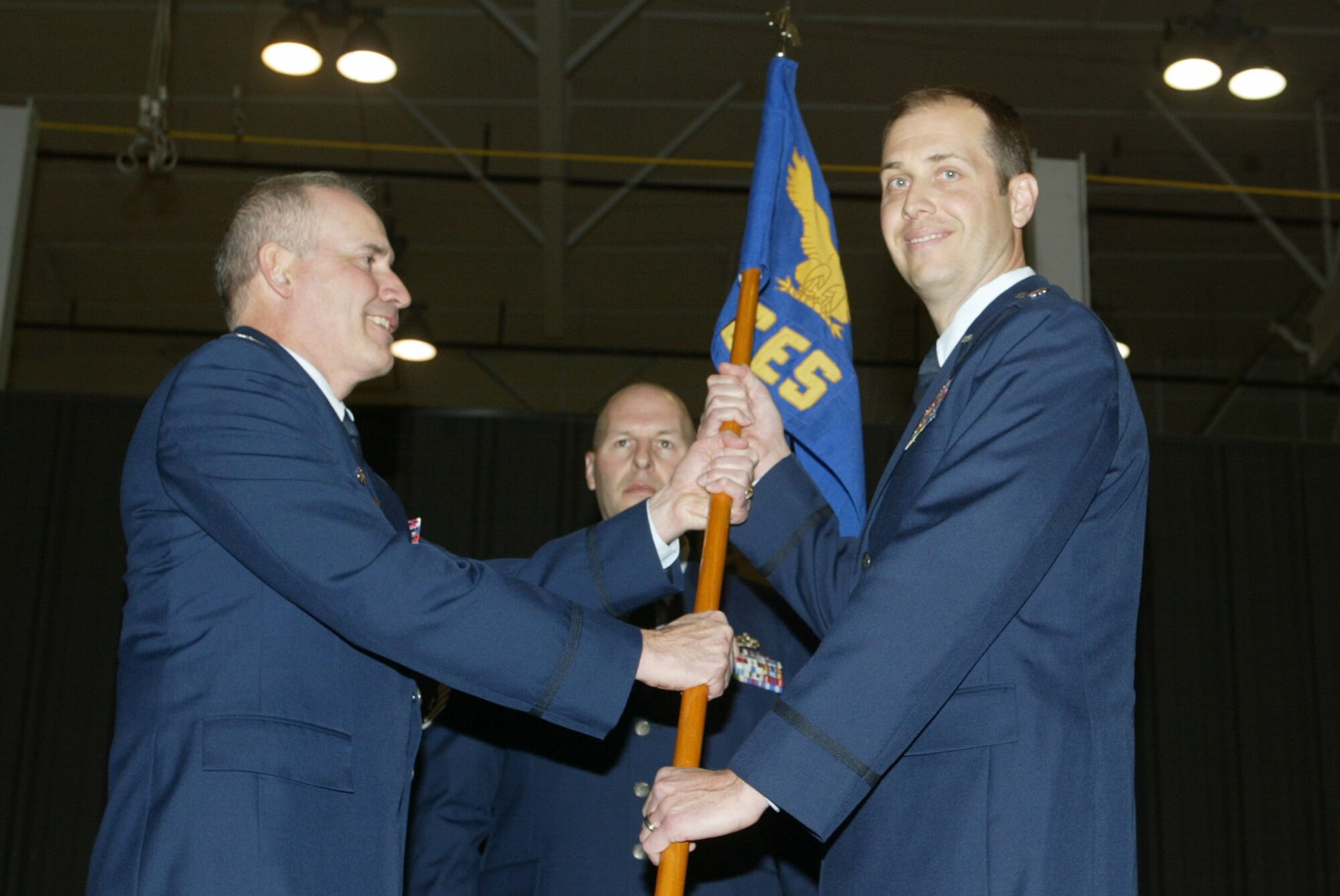 Lt. Col. Christopher Whitehead receives the unit flag from Col. Steven Slick, Commander of the 94th Mission Support Group, as he accepts the position of Commander of 94th Civil Engineering Squadron at a ceremony held Jan. 10. (U.S. Air Force photo/Don Peek)