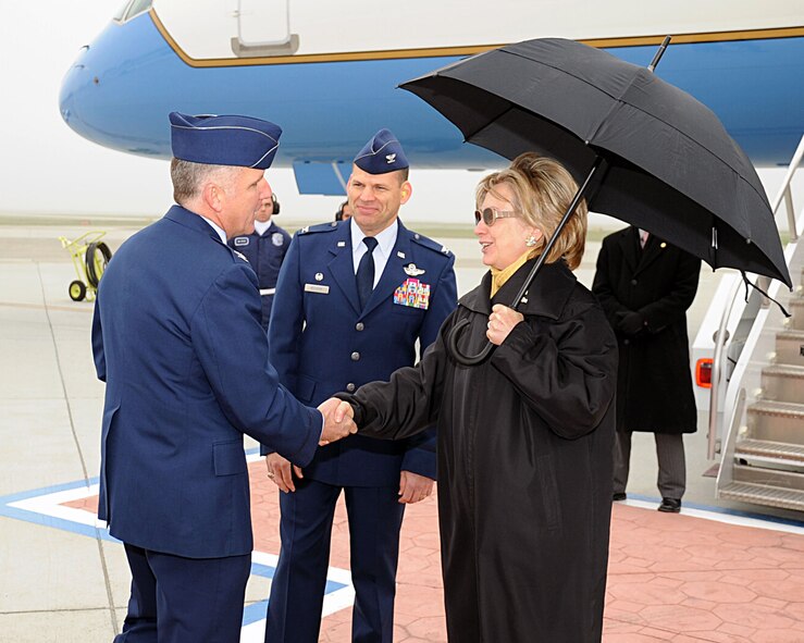 TRAVIS AIR FORCE BASE, Calif. - Secretary of State Hillary Rodham Clinton stopped and met with base leadership as her plane stopped at Travis Air Force Base to refuel on the first leg of a trip taking her to Hawaii, Australia, New Zealand and Papua New Guinea, Jan. 11.  Col. John C. Flournoy, Jr., 349th Air Mobility Wing commander greets Secretary Clinton as the 60th AMW commander, Col. James C. Vechery, looks on. (U.S. Air Force photo/David Cushman) 