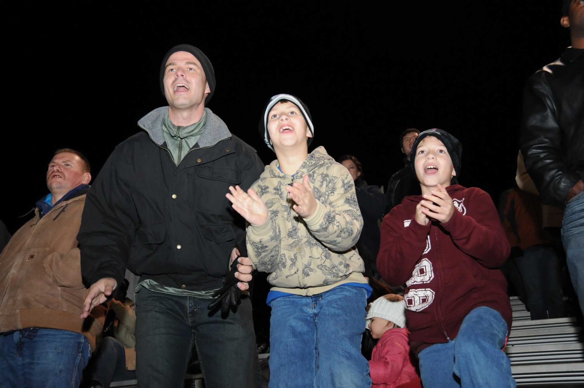 Todd Galloway, 336th Training Squadron, and his sons, Michael, 9, and Matthew, 8, cheer for Troy University.  (U.S. Air Force photo by Kemberly Groue)