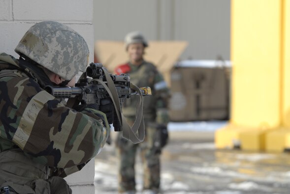 Senior Airman Dustin Wells, 8th Security Forces Squadron, defends his position from opposing forces members while an 8th Fighter Wing Exercise Evaluation Team member evaluates how the situation is handled during a Peninsula-wide Operational Readiness Exercise here, Jan. 12. PENOREs like this one ensure that all Wolf Pack members are capable of performing their duties in wartime conditions, that they are ready to defend the base, accept follow on forces and take the fight north. (U.S. Air Force photo/Staff Sgt. Darnell T. Cannady)