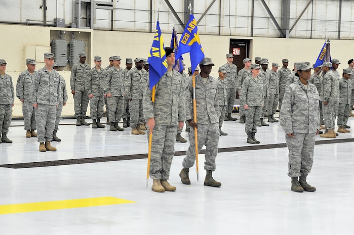 Tech. Sgt. Sloan Kalina, left, prepares to deactivate the 437th Mission Support Group flag as Airman 1st Class Anthony Burdett, center, activates the new 628th Mission Support Group flag during the 628th Air Base Wing activation ceremony here Jan. 8. Along with the activation of the 628 MSG, the 628th Medical Group was also activated under the 628 ABW. Sergeant Sloan is assigned to the 628th Security Forces Squadron and Airman Burdett is assigned to the 628th Logistics Readiness Squadron. (U.S. Air Force photo/Staff Sgt. Marie Brown)