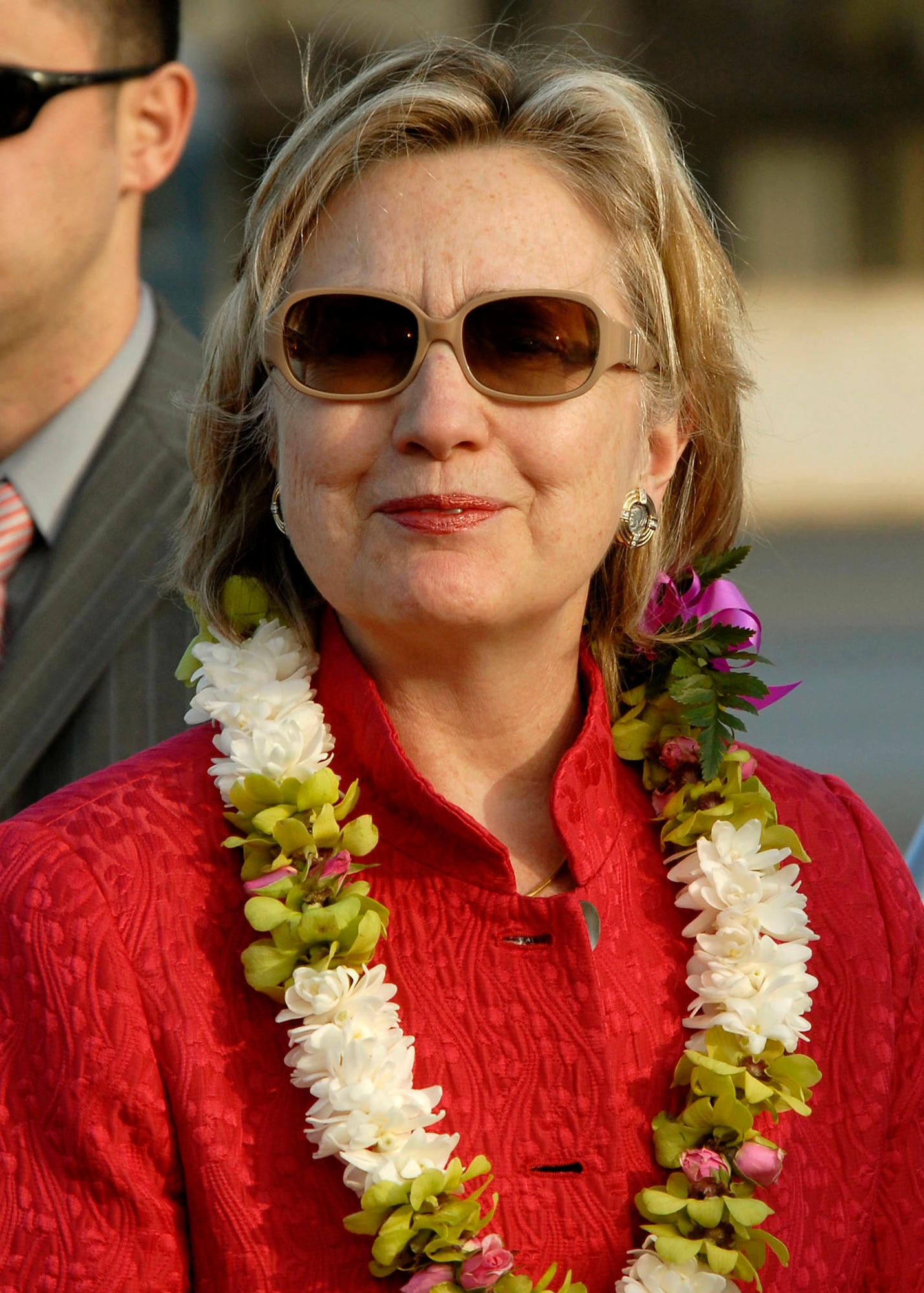 HICKAM AIR FORCE BASE, Hawaii - Secretary of State Hillary Rodham Clinton smiles after receiving a Hawaiian flower lei upon her arrival at Hickam Air Force Base Hawaii, on Jan. 11.  Clinton is kicking off her 2010 diplomacy agenda, to strengthen U.S. relations with key partner nations in the western Pacific, with a 10-day trip scheduled to take her to Australia, New Zealand and Papua New Guinea, with a stop in Hawaii to give a policy speech and a one-on-one meeting with her Japanese counterpart.  (U.S. Air Force photo/Tech Sgt. Jerome S. Tayborn)