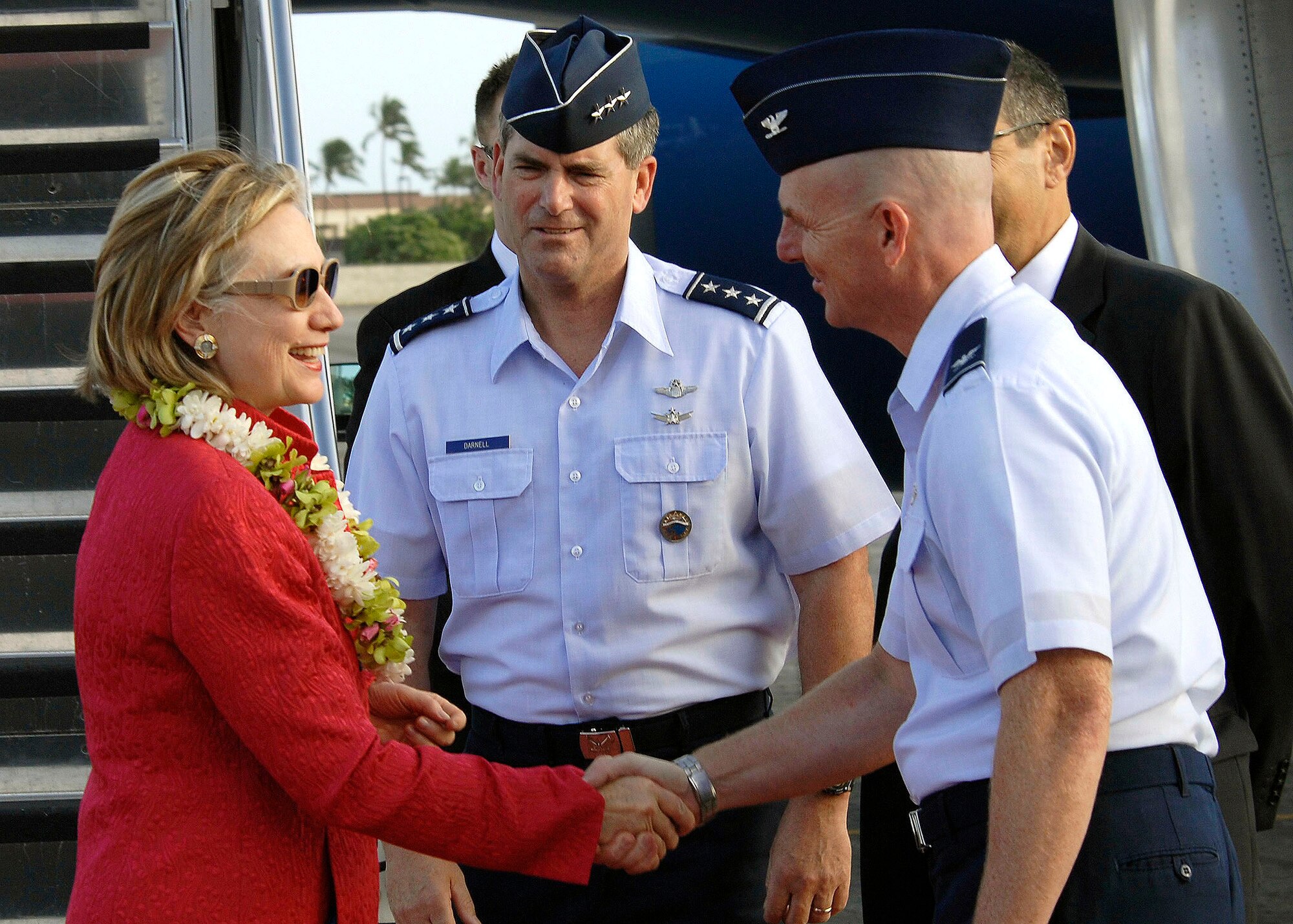 HICKAM AIR FORCE BASE, Hawaii - Lieutenant General Daniel J. Darnell, Deputy Commander, U.S. Pacific Command and 15th Airlift Wing vice commander, Colonel Sam C. Barrett welcomes, Secretary of State Hillary Rodham Clinton upon her arrival here, at Hickam Air Force Base Hawaii, on Jan. 11.  Clinton is kicking off her 2010 diplomacy agenda, to strengthen U.S. relations with key partner nations in the western Pacific, with a 10-day trip scheduled to take her to Australia, New Zealand and Papua New Guinea, with a stop in Hawaii to give a policy speech and a one-on-one meeting with her Japanese counterpart.  (U.S. Air Force photo/Tech Sgt. Jerome S. Tayborn)
