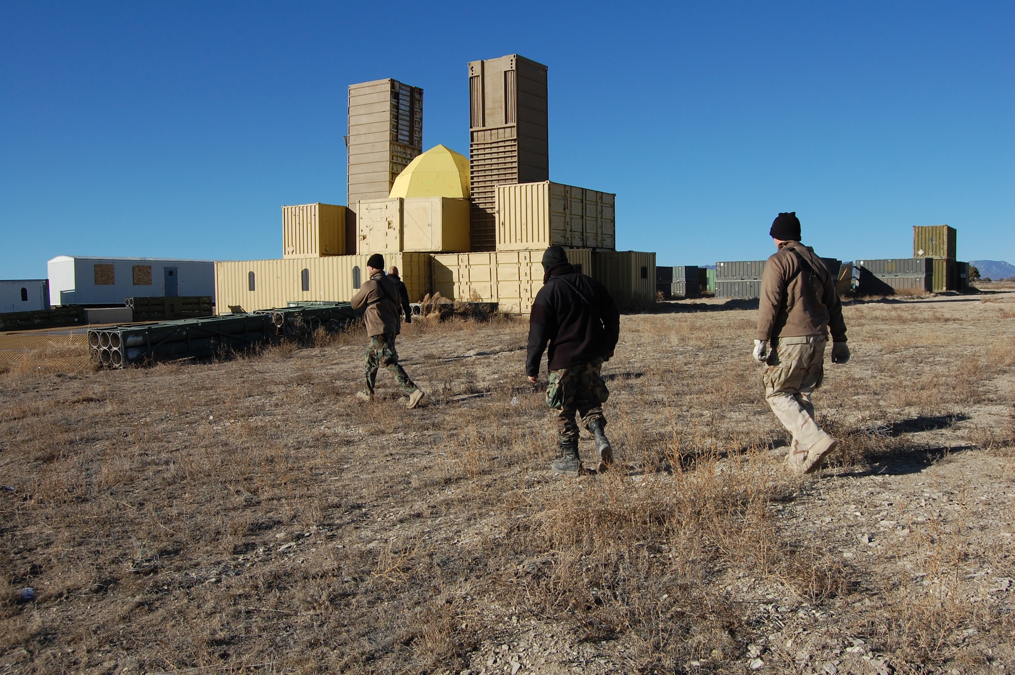 Airburst Range members walk to village in preparation for the close air support scenario.  The team acted as opposing forces for the 13th Air Support Operations Squadron Joint Termainal Attack Controller training.
