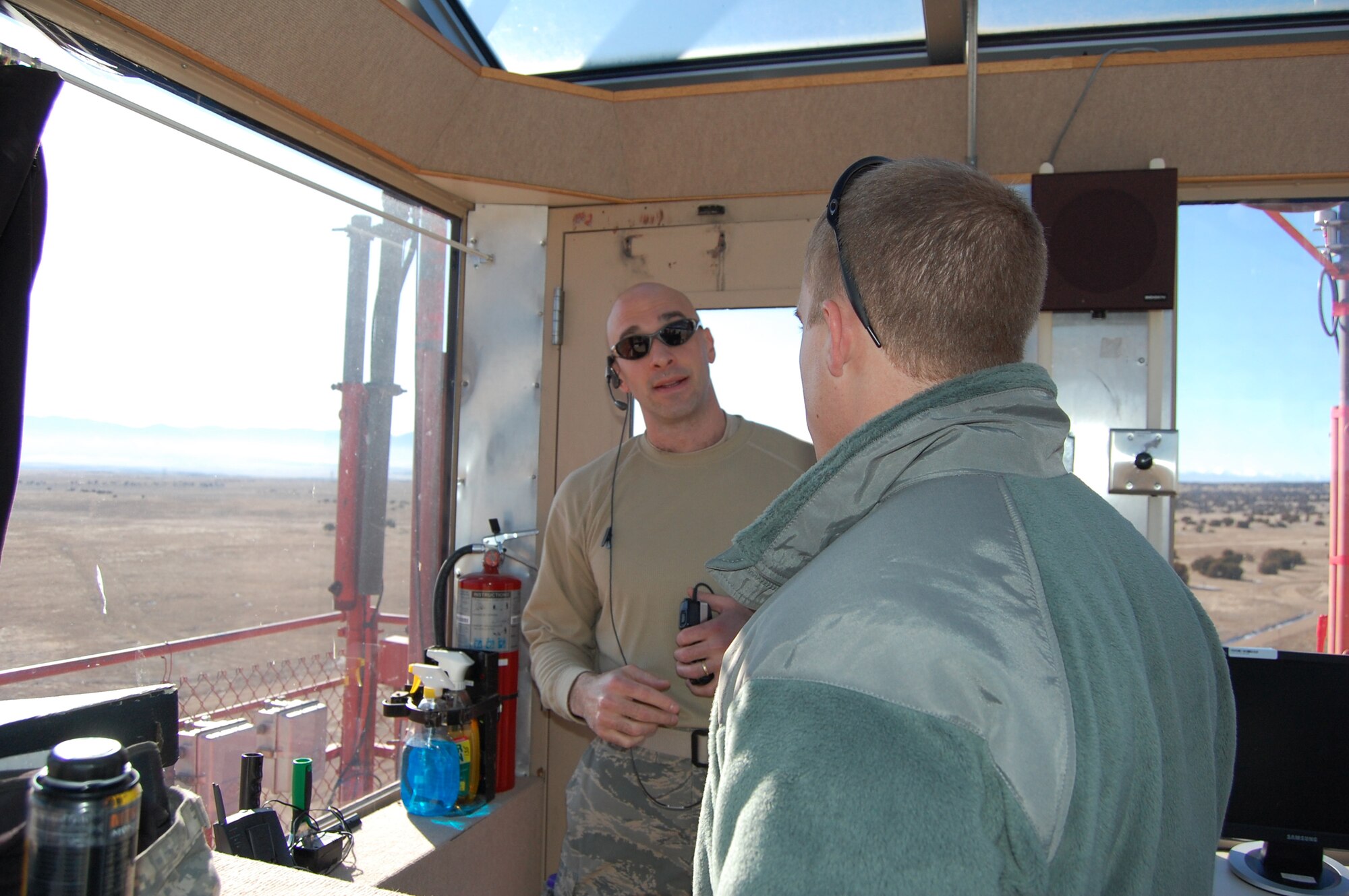 Maj. John Stevenson, the Airburst Range Commander, briefs an observing Army 1st Lt. about the upcoming scenario from the Airburst Range Tower.