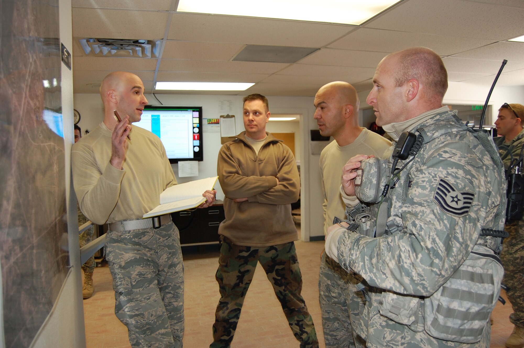 Airburst Range Commander, Maj. John Stevenson, pre-briefs upcoming scenario details to Master Sgt. Manuel Gomez, Range Vehicle Maintenance NCOIC and Tech. Sgt. Thomas Schaefer, 13th ASOS standardization and evaluation instructor.