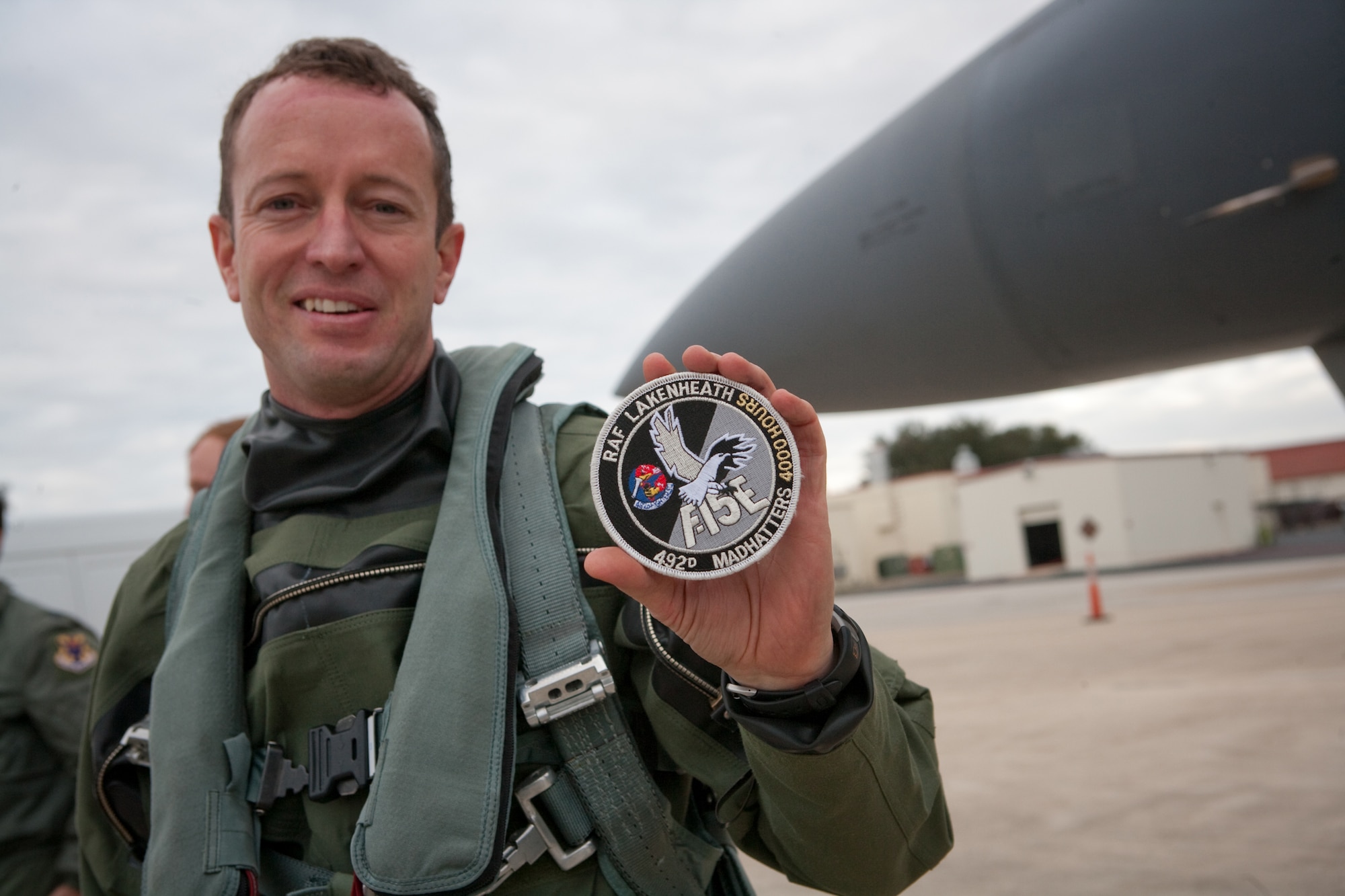 Seventeen years in the making, Lt. Col. David Iverson holds the 4,000 hours patch he can now wear after a 10.1 hour flight in an F-15E Strike Eagle from Royal Air Force Lakenheath, England, to Lackland Air Force Base, Texas, Jan. 11, 2010. (Courtesy Boeing photo/Lance Cheung)