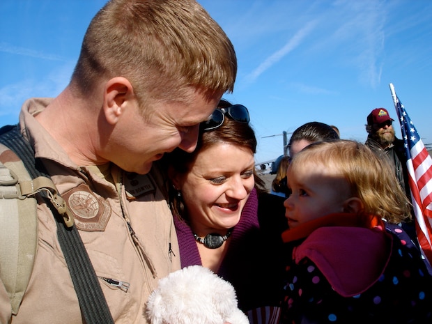 Capt. Bowyer gets a big welcome home from his wife Tristah and their daughter Addison, 15 months, on the flightline here Jan. 3. The 17th Airlift Squadron returned home from their 120-day deployment in the Middle East where they supported Operations Iraqi and Enduring Freedom as well as the Horn of Africa. Capt. Bowyer is a pilot with the 17 AS. (U.S. Air Force photo/Trisha Gallaway)