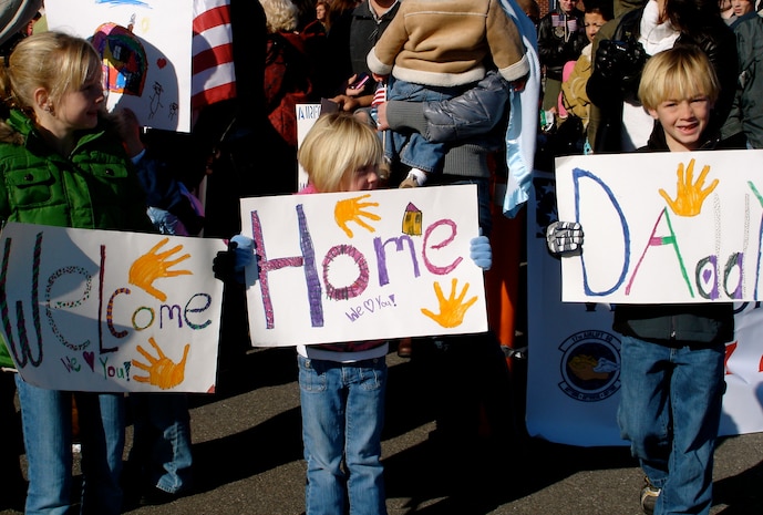 Maddie Williamson, age 10; Caity Williamson, age 8; and Cole Williamson, age 5 wait for their dad, Col. Richard Williamson to come off the plane on the flightline here Jan. 3. The 17th Airlift Squadron returned home from their 120-day deployment in the Middle East where they supported Operations Iraqi and Enduring Freedom as well as the Horn of Africa. Colonel Williamson is the 17 AS commander. (U.S. Air Force photo/Trisha Gallaway)