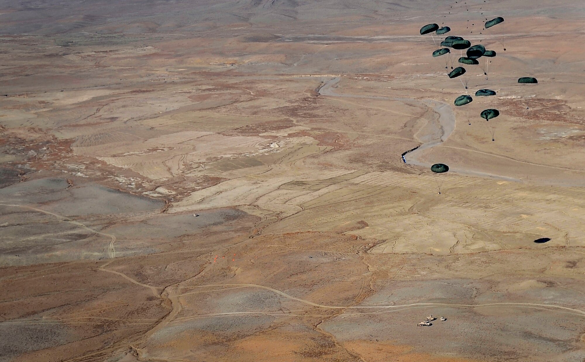 Container delivery system bundles descend toward a drop zone in Afghanistan. A C-17 Globemaster III aircrew, assigned to the 816th Expeditionary Airlift Squadron, loaded and air dropped the bundles to U.S. ground forces Jan. 9, 2010. (U.S. Air Force photo/ Staff Sgt. Angelita Lawrence) (released)