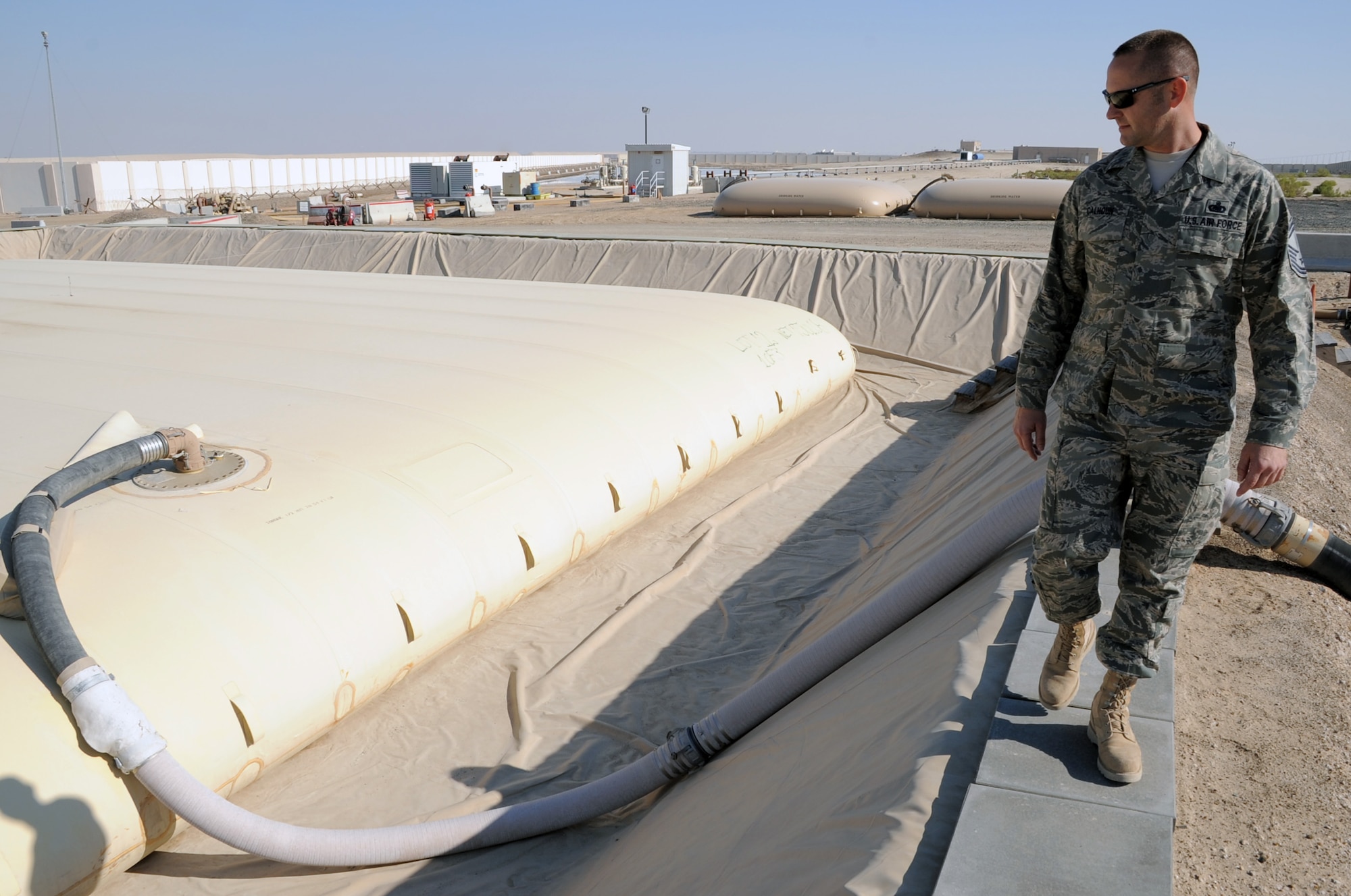 Senior Master Sgt. James Calhoun, superintendent of the 380th Expeditionary Logistics Readiness Squadron fuels management flight, checks a 200,000-gallon fuel bladder at the fuel bladder storage facility at a non-disclosed base in Southwest Asia on Jan. 6, 2010.  On any given day, Sergeant Calhoun and other fuels Airmen in his flight can off-load up to 600,000 gallons of fuel from host nation supplier fuel trucks which is then stored to one of 16 fuel bladders.  In 2009, the 380th ELRS fuels management flight pumped more than 188 million gallons of fuel in support of Operations Iraqi Freedom and Enduring Freedom and the Combined Joint Task Force-Horn of Africa.  Sergeant Calhoun is deployed from the 6th Logistics Readiness Squadron at MacDill Air Force Base, Fla., and his hometown is Owensboro, Ky.  (U.S. Air Force Photo/Tech. Sgt. Scott T. Sturkol/Released)