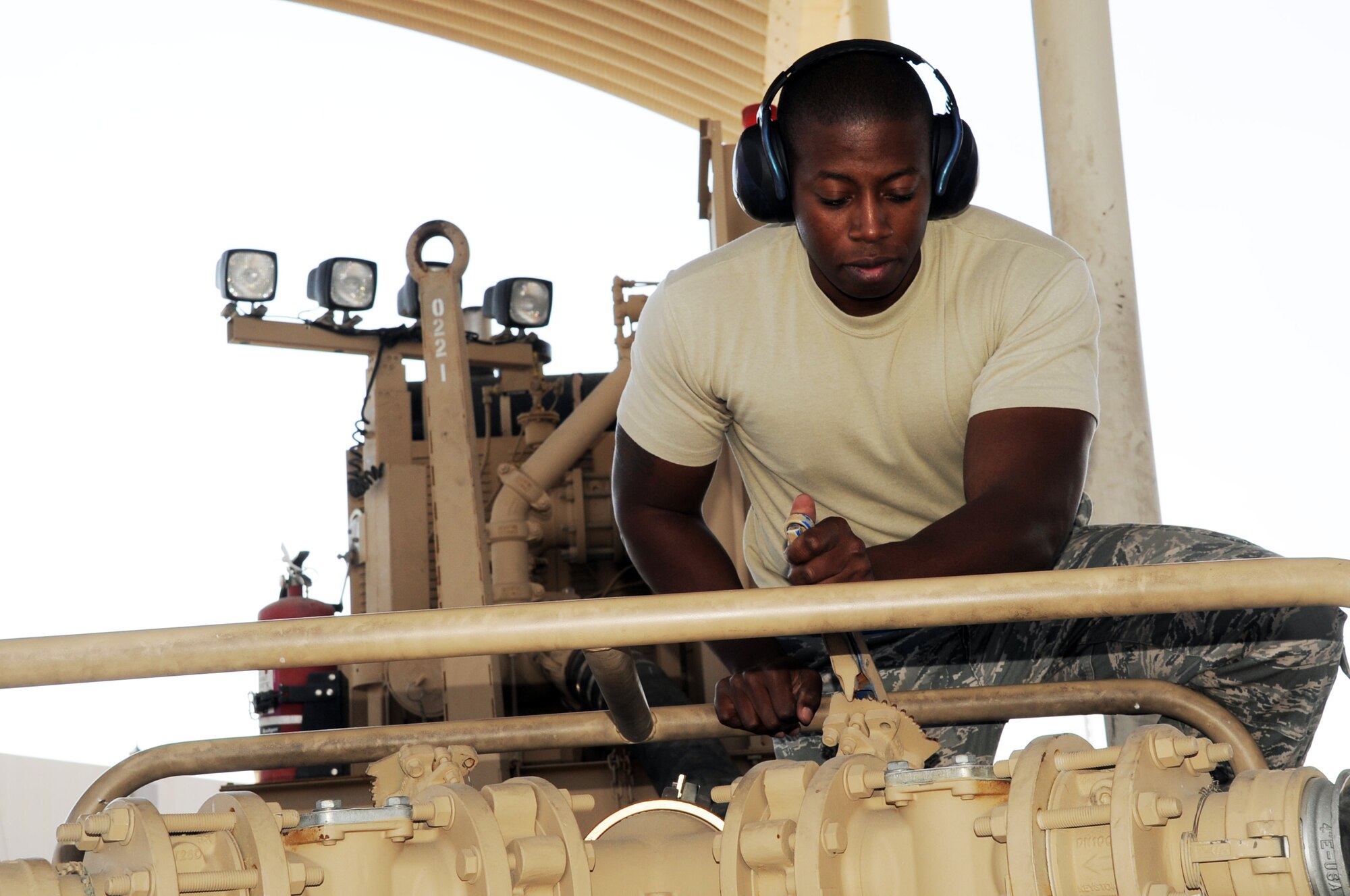 Senior Airman Brandon Bailey, a fuels distribution journeyman with the 380th Expeditionary Logistics Readiness Squadron fuels management flight, adjusts an R-18 fuel pump during operations at the fuel off-load facility at a non-disclosed base in Southwest Asia on Jan. 6, 2010.  On any given day, Airman Bailey and other fuels Airmen in his flight can off-load up to 600,000 gallons of fuel from host nation supplier fuel trucks.  In 2009, the 380th ELRS fuels management flight pumped more than 188 million gallons of fuel in support of Operations Iraqi Freedom and Enduring Freedom and the Combined Joint Task Force-Horn of Africa.  Airman Bailey is deployed from the 914th Logistics Readiness Squadron at Niagara Falls Air Reserve Station, N.Y., and his hometown is Buffalo, N.Y.  (U.S. Air Force Photo/Tech. Sgt. Scott T. Sturkol/Released)