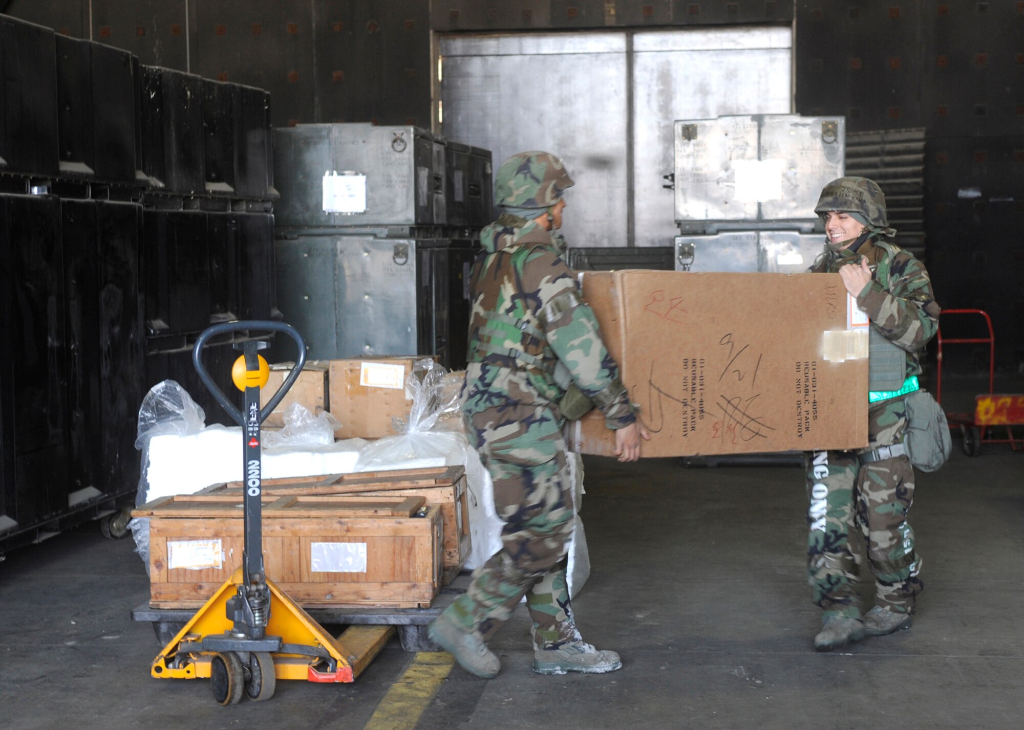 Airmen 1st Class Jordan Gibson and Kenneth Pereira unload parts to put together an aircraft parts kit for an F-16 during Operational Readiness Exercise Beverly Bulldog 10-01 at Osan Air Base, Republic of Korea, Jan. 12. Aircraft parts kits are issued to aircraft in case they are in need of repair. The F-16 is going TDY to Thailand and the Philippines next month.  Both Airmen are aircraft parts store journeyman from the 51 Logistics Readiness Squadron. (U.S. Air Force photo/Senior Airman Stephenie Wade)

