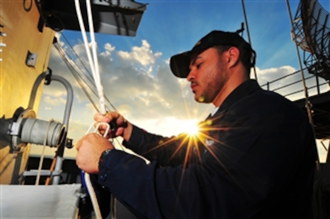 U.S. Navy Petty Officer 3rd Class Luis Torres prepares to hoist the chief of naval operations' flag aboard the aircraft carrier USS Nimitz (CVN 68) in the North Arabian Gulf on Jan. 6, 2010.  The Nimitz and embarked Carrier Air Wing 11 are deployed to the Western-Pacific region.  