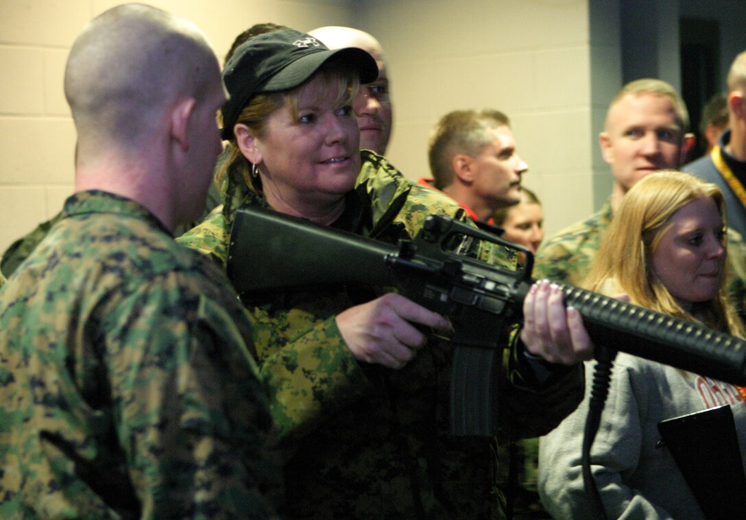 Nancy Santilli, the principal of Kenston High School in Chagrin Falls, Ohio, waits for the command to sight in on her simulated target during Recruiting Station Cleveland’s Educator Workshop, Jan. 12-15, 2010. Santilli was greatly impressed with the discipline and sense of pride that the recruits learn during boot camp. At the Kenston’s graduation ceremony, she presented the students with a challenge coin, modeled from many Marine Corps challenge coins.