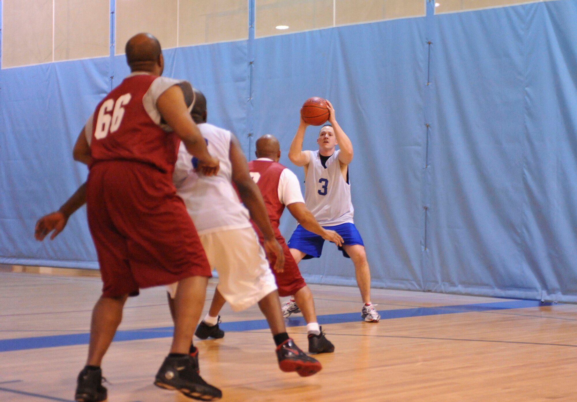 ELMENDORF AIR FORCE BASE, Alaska – The 3rd Civil Engineer Squadron’s James Shultz looks for an open man, during an over-30 intramural playoff game against the 3rd Medical Support Squadron, Jan. 13 at Elmendorf’s Fitness Center. The 3rd CES won by the a score of 45-43. (Air Force photo by Airman 1st Class Christopher Gross)