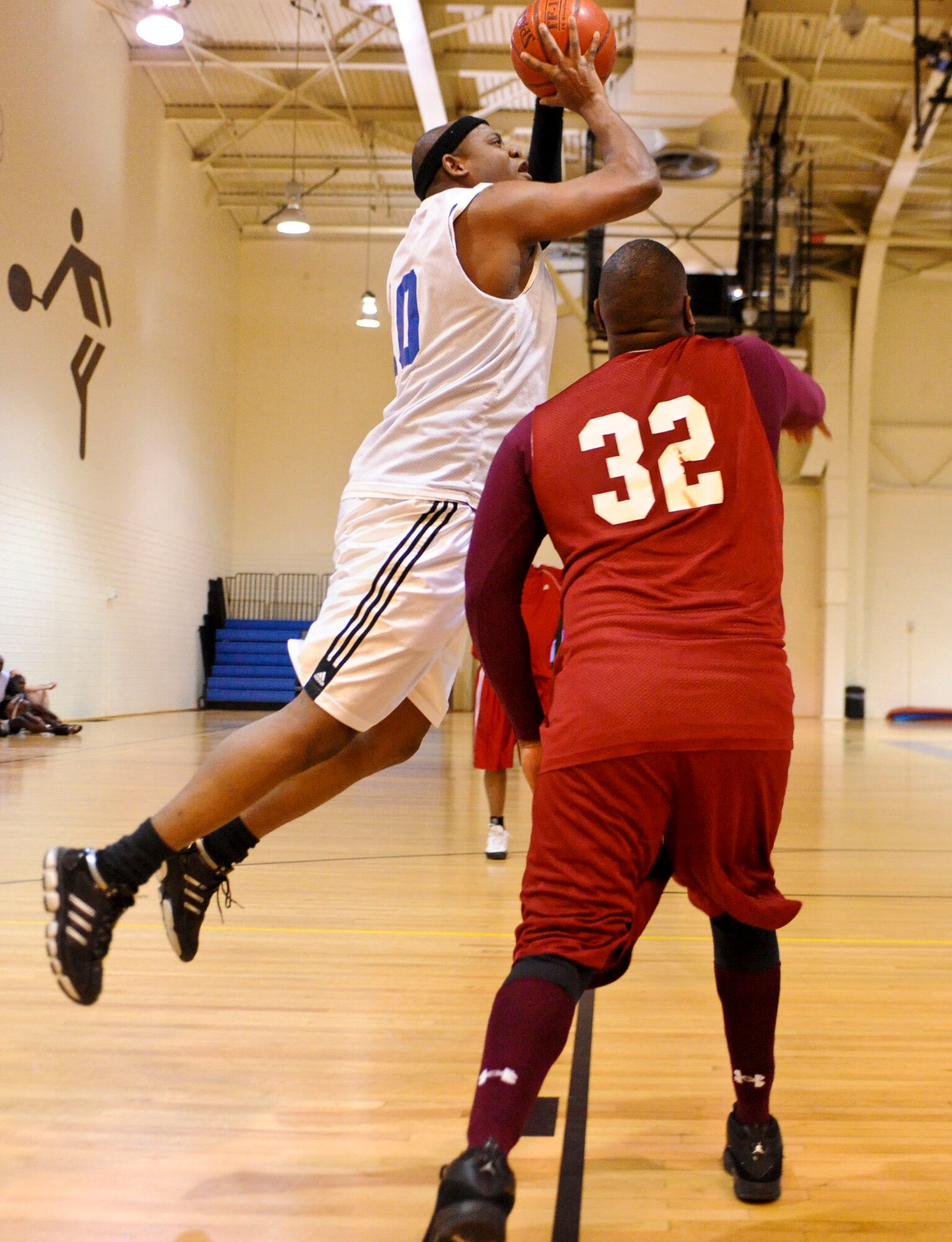 ELMENDORF AIR FORCE BASE, Alaska – The 3rd Civil Engineer Squadron’s Nakia Graham shoots over 3rd Medical Support Squadron’s Nathan Hanzy during an over-30 intramural playoff game Jan. 13 at Elmendorf’s Fitness Center. The 3rd MDSS stayed close to the 3rd CES throughout the game tying it up at 43-43 with 42 seconds remaining in the game. However that wasn’t enough because the 3rd CES hit a couple of free throws at the end of the game for the deciding points to win it by the score of 45-43. (Air Force photo by Airman 1st Class Christopher Gross)

