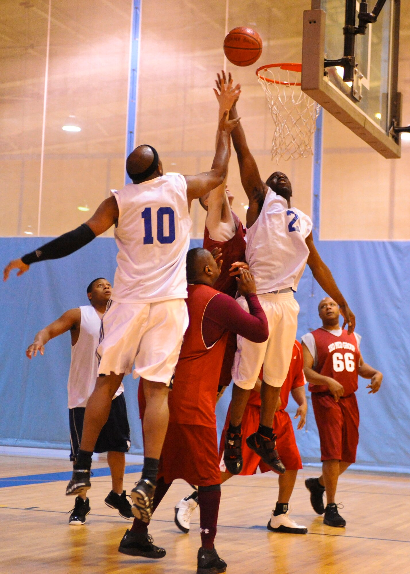 ELMENDORF AIR FORCE BASE, Alaska – The 3rd Civil Engineer Squadron’s Nakia Graham, 10, Chris Downing, 2, along with the 3rd Medical Support Squadron’s Lee Mills go up for a rebound during  an over-30 intramural playoff game Jan. 13 at Elmendorf’s Fitness Center. The 3rd CES won by the score of 45-43. (Air Force photo by Airman 1st Class Christopher Gross)