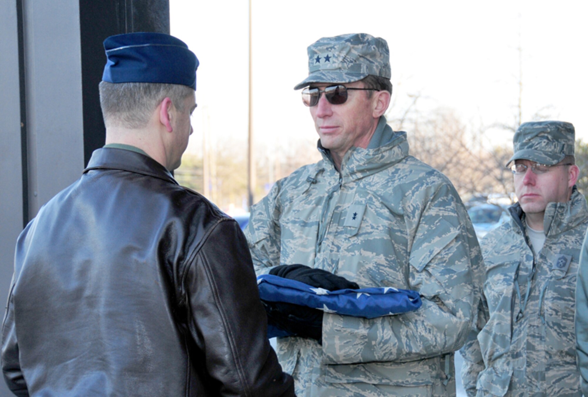 Maj. Gen. James T. Rubeor, commander, 22nd Air Force receives the flag from Col. Darrin Simmonds, commander, 94th Operations Support Squadron during retreat Jan. 9. (U.S. Air Force photo: Tech. Sgt. Nicholas Ontiveros)