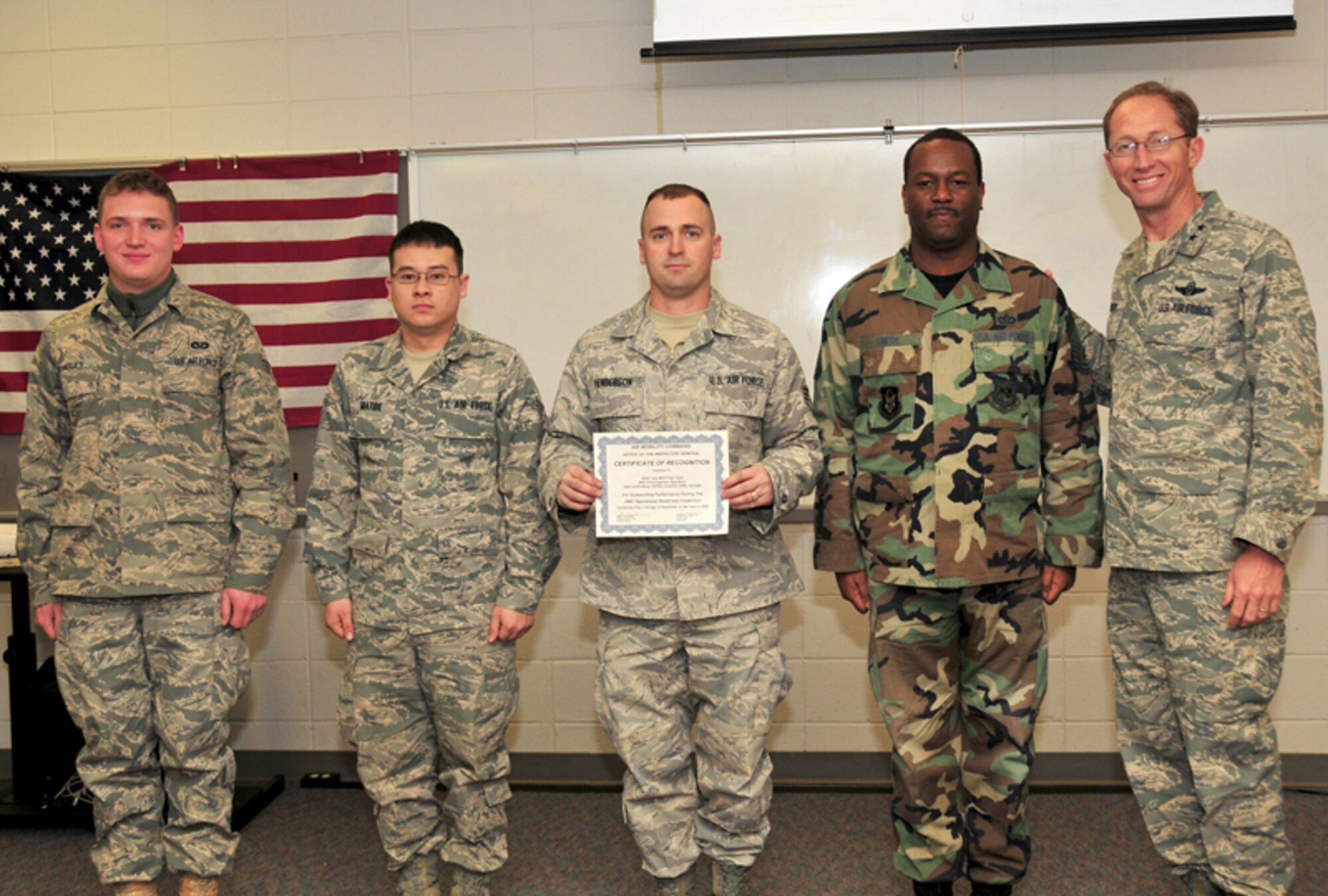 Maj. Gen. James T. Rubeor, commander, 22nd Air Force presents a Certificate of Recognition from the Air Mobility Command Office of the Inspector General to 94th Civil Engineering Squadron Cell Team members, Senior Airman Evan W. Whatley, civil engineering journeyman, Senior Airman Christopher A. Matibe, civil engineering journeyman, Staff Sgt. Sean Henderson, civil engineering journeyman and Senior Master Sgt. Sheldon D. Smith, engineering superintendant Jan. 9. The team was recognized outstanding performance during the AMC Operational Readiness inspection conducted Dec. 11, 2009. (U.S. Air Force photo: Tech. Sgt. Nicholas Ontiveros)