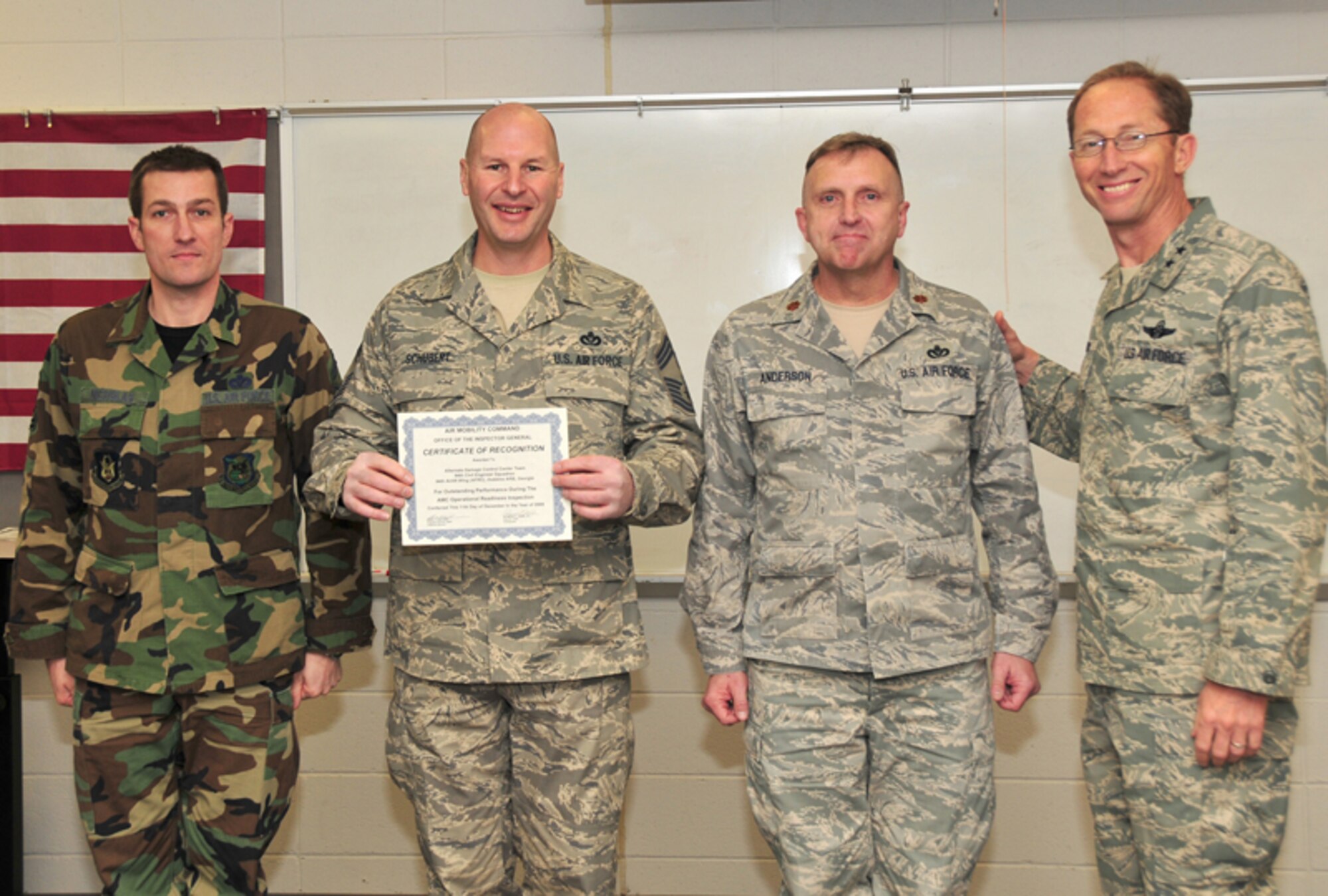 Maj. Gen. James T. Rubeor, commander, 22nd Air Force presents a Certificate of Recognition from the Air Mobility Command Office of the Inspector General to 94th Civil Engineering Squadron Alternate Damage Control Center Team members, Senior Master Sgt. Stephen D. Nicholas, structural helper, Chief Master Sgt. Mark J. Schubert, civil engineering manager and Maj. Gregory Anderson, civil engineering officer Jan. 9. The team was recognized outstanding performance during the AMC Operational Readiness inspection conducted Dec. 11, 2009. (U.S. Air Force photo: Tech. Sgt. Nicholas Ontiveros)