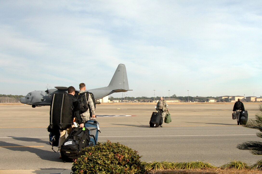 Air Force Special Operations Command Airmen carry gear to an MC-130H Combat Talon II before departing for Haiti, Jan. 13, 2010.  These Airmen will participate in the U.S. humanitarian assistance and disaster relief mission in Haiti. (U.S. Air Force photo by Senior Airman Matthew Loken/Released)