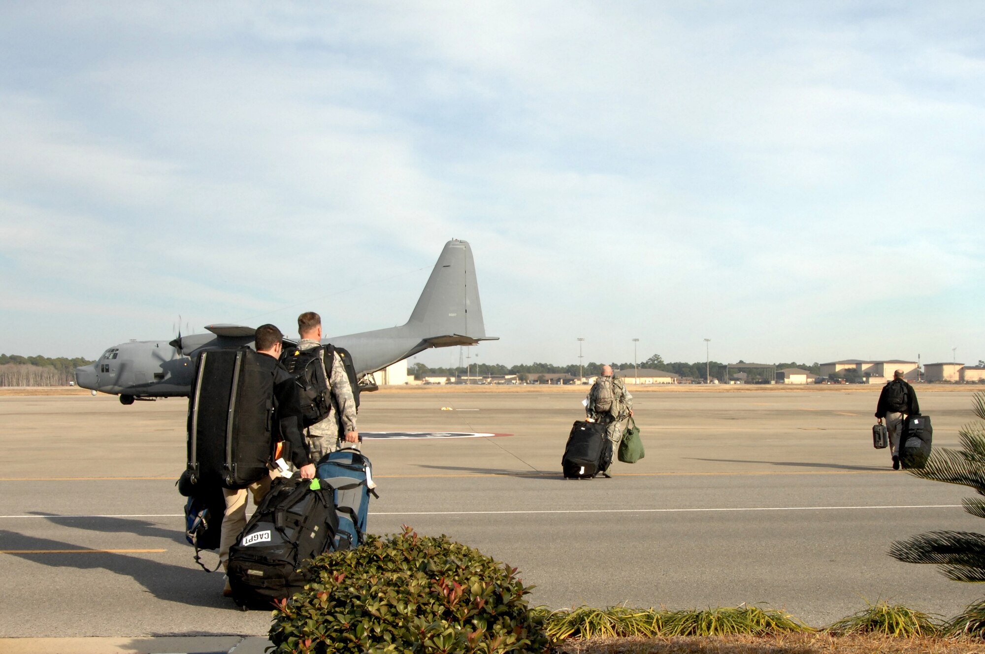 Air Force Special Operations Command Airmen carry gear to an MC-130H Combat Talon II before departing for Haiti, Jan. 13, 2010.  These Airmen will participate in the U.S. humanitarian assistance and disaster relief mission in Haiti. (U.S. Air Force photo by Senior Airman Matthew Loken/Released)