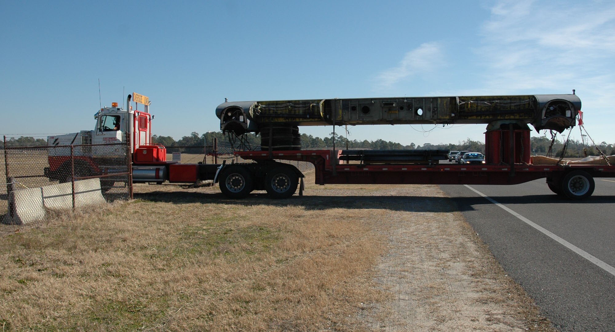 A flatbed tractor trailer delivers the wing section of a C-130 to Hurlburt Field, Jan. 13.  The wings and fuselage will be used as a simulator for ground, loading and maintenance training to reduce the burden of using flightline airframes for most of these tasks.   (Air Force photo by Airman 1st Class Joe McFadden)
