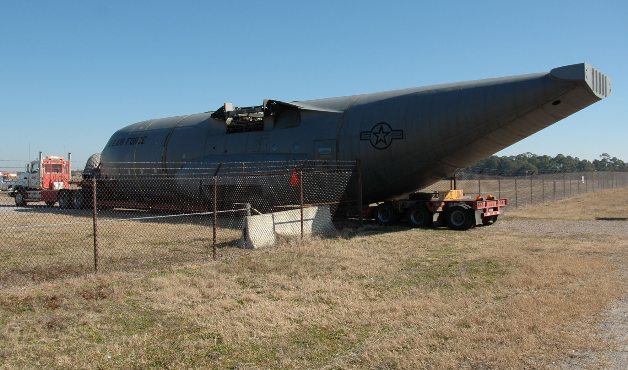 A flatbed tractor trailer delivers a C-130 fuselage to Hurlburt Field, Jan. 13. The fuselage will be used as a simulator for ground, loading and maintenance training to reduce the burden of using flightline airframes for most of these tasks.  (Air Force photo by Airman 1st Class Joe McFadden)
