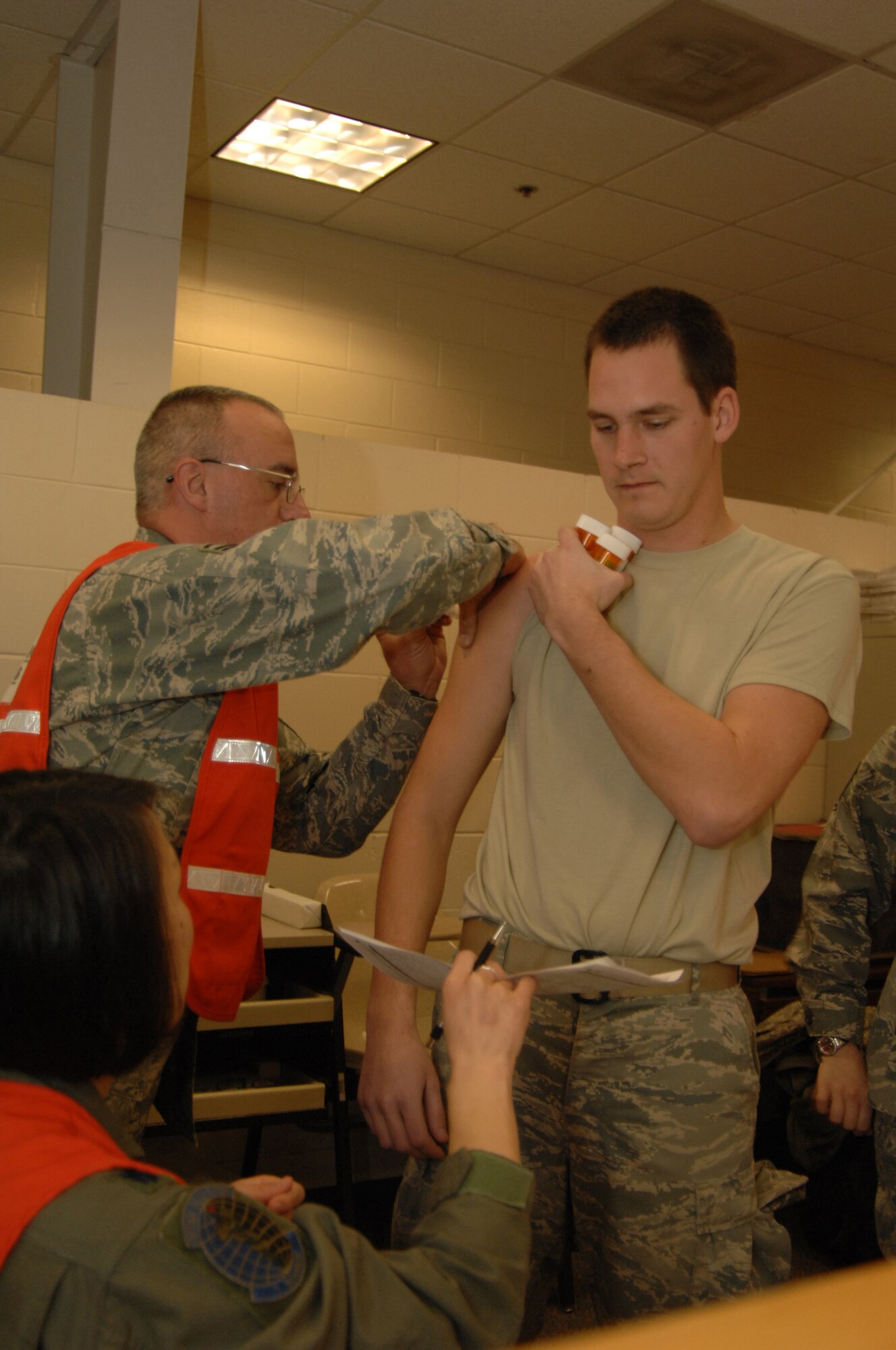 U.S. Air Force Airman 1st Class Anthony Morio, 1th Special Operations Communication Squadron at Hurlburt Field, Fla., receives an immunization while processing through a mobility line before departing for Haiti, Jan. 13, 2010, Hurlburt Field, Fla. Airmen assigned to the 1st Special Operations Wing will be part of a U.S. humanitarian relief mission to the earthquake stricken country. (U.S. Air Force photo by Senior Airman Matthew Loken/Released)