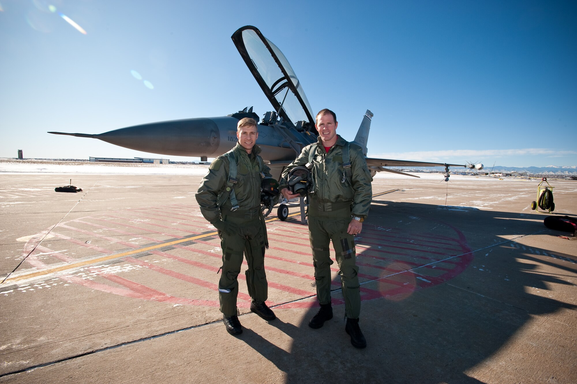 U.S. Air Force Major Marc 'Kidd' Garceau, F-16 fighter pilot, 120th Fighter Squadron, Buckley Air Force Base, and Pro Rodeo Cowboy Association rider Josh Peek pause for a photo prior to his orientation flight, Jan 8, 2010.  (U.S. Air Force photo/Master Sgt. John Nimmo, Sr.) (RELEASED)

