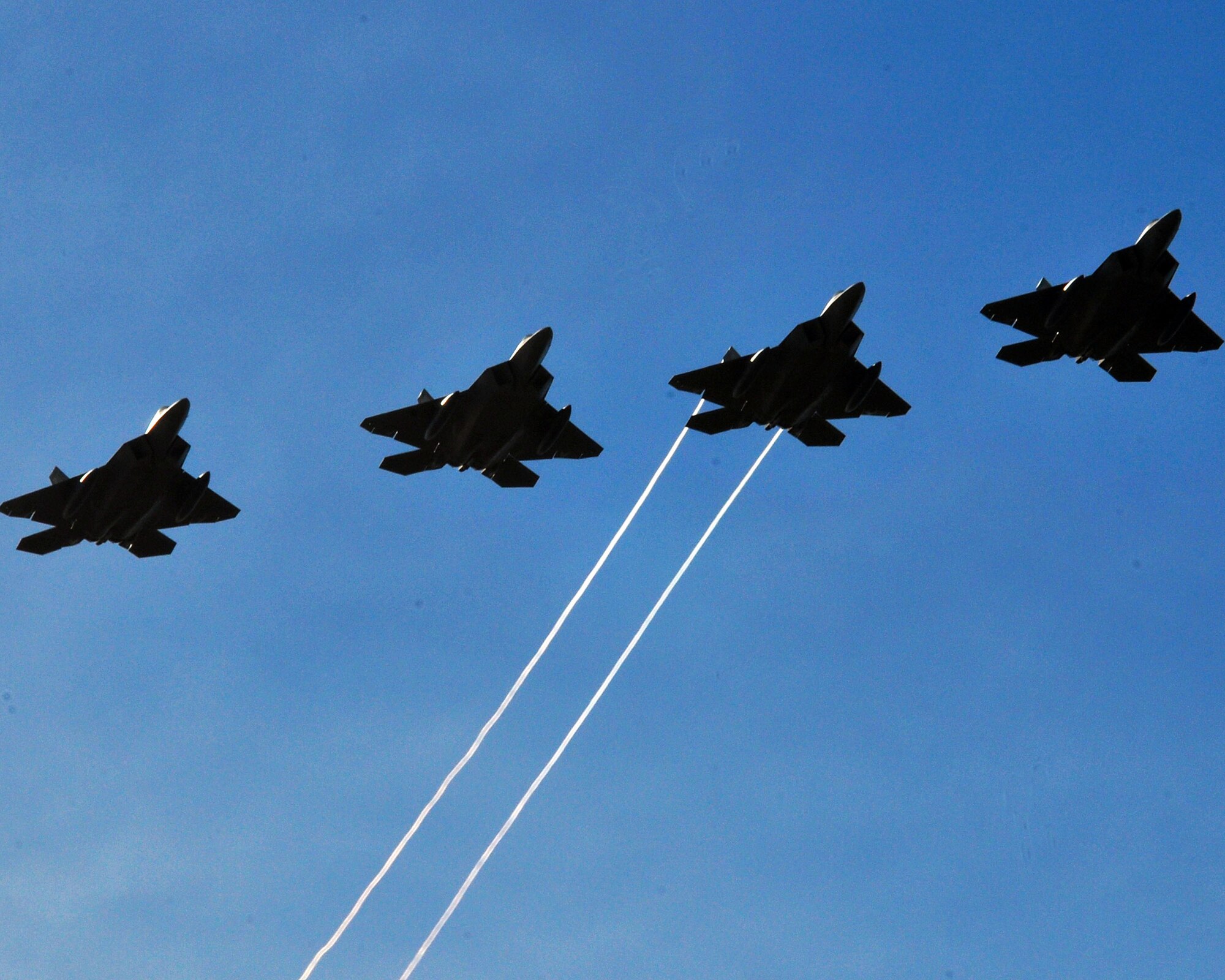 Four F-22 Raptors perform their initial flight over Andersen Air Force Base, Guam, Jan. 13, 2010. The Raptors are assigned to the 90th Fighter Squadron at Elmendorf AFB, Alaska, and are forward deployed to support the Theater Security Packages in the Pacific region.  (U.S. Air Force photo/Airman 1st Class Julian North)