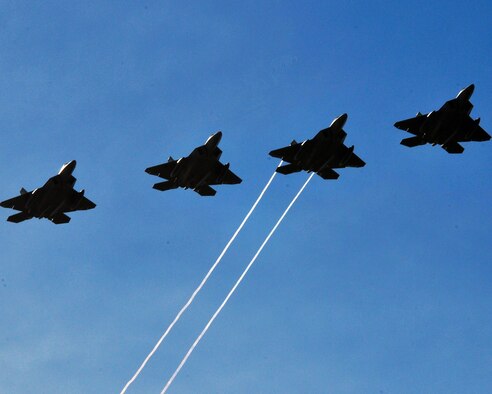 Four F-22 Raptors perform their initial flight over Andersen Air Force Base, Guam, Jan. 13, 2010. The Raptors are assigned to the 90th Fighter Squadron at Elmendorf AFB, Alaska, and are forward deployed to support the Theater Security Packages in the Pacific region.  (U.S. Air Force photo/Airman 1st Class Julian North)