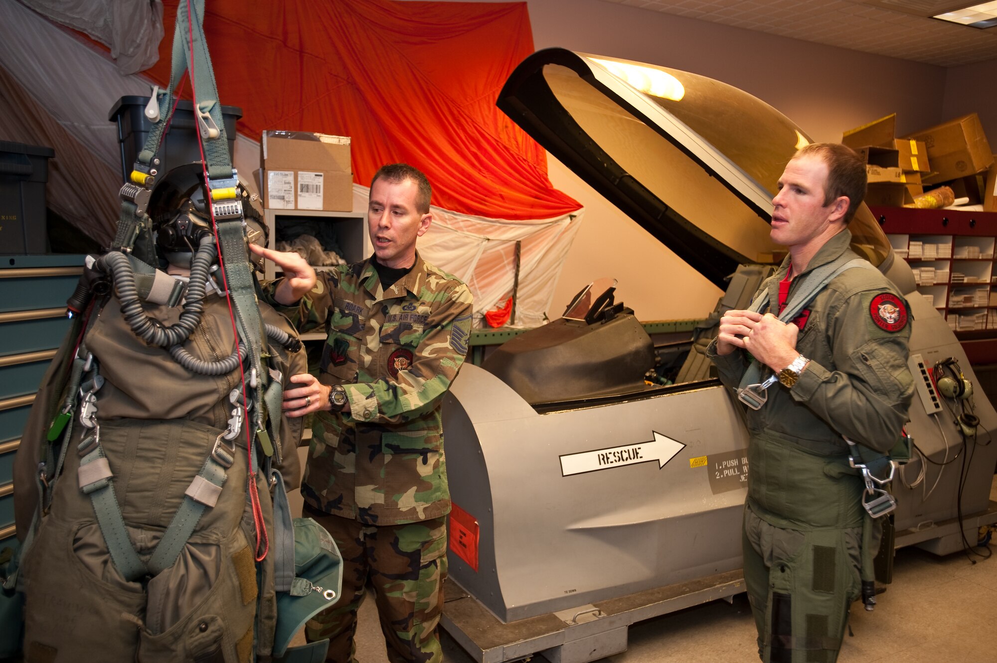 U.S. Air Force Master Sergeant Gregory Roark, life support specialist with the 120th Fighter Squadron, Buckley Air Force Base, explains parachute detangling maneuvers to Pro Rodeo Cowboy Association rider Josh 'Jack Daniels' Peek, Jan 8, 2010. (U.S. Air Force photo/Master Sgt. John Nimmo, Sr.) (RELEASED)
