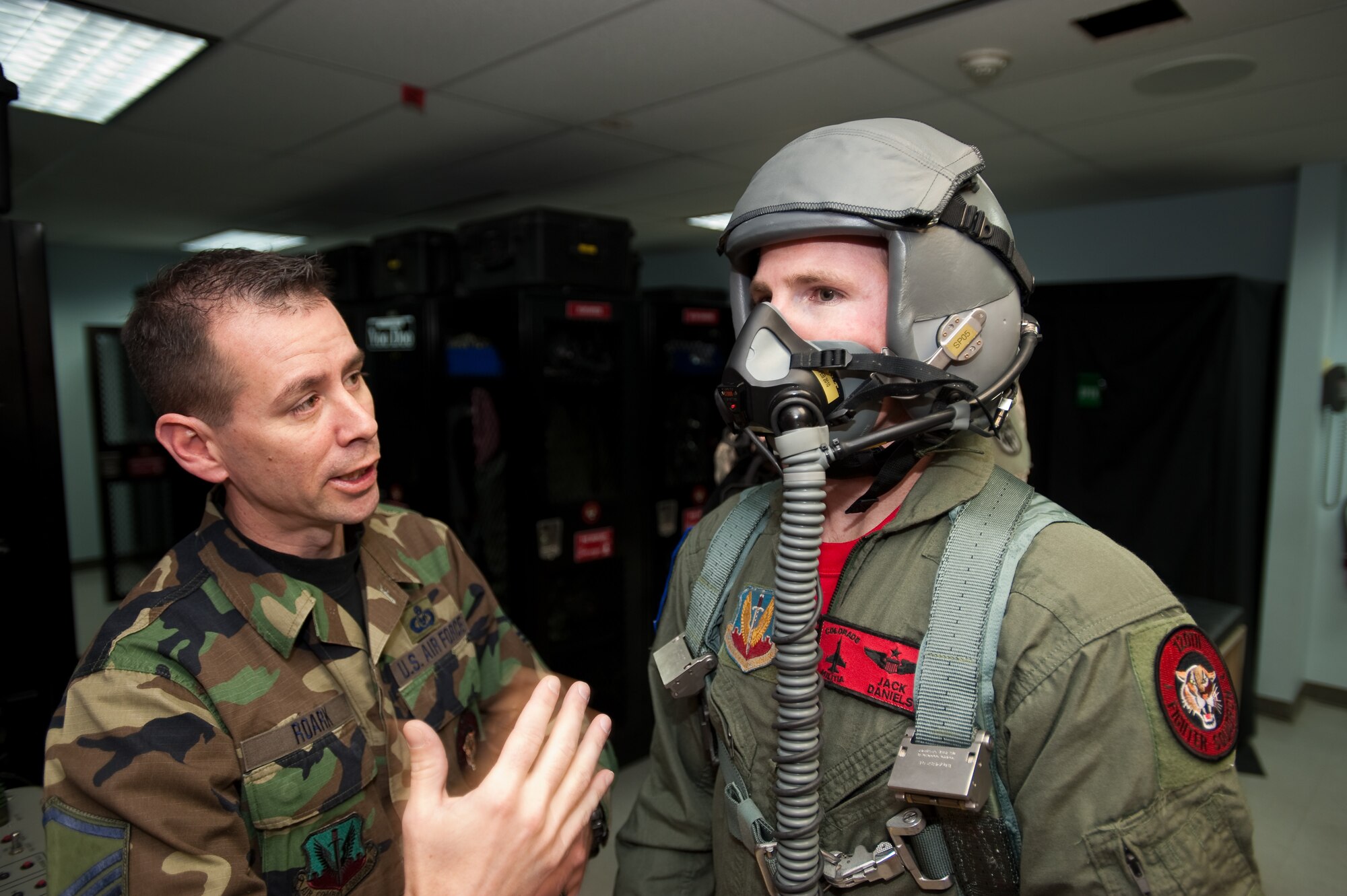 Pro Rodeo Cowboy Association rider Josh 'Jack Daniels' Peek receives oxygen mask training prior to his orientation flight from U.S. Air Force Master Sergeant Gregory Roark, life support specialist with the 120th Fighter Squadron, Buckley Air Force Base,  Jan 8, 2010. (U.S. Air Force photo/Master Sgt. John Nimmo, Sr.) (RELEASED)