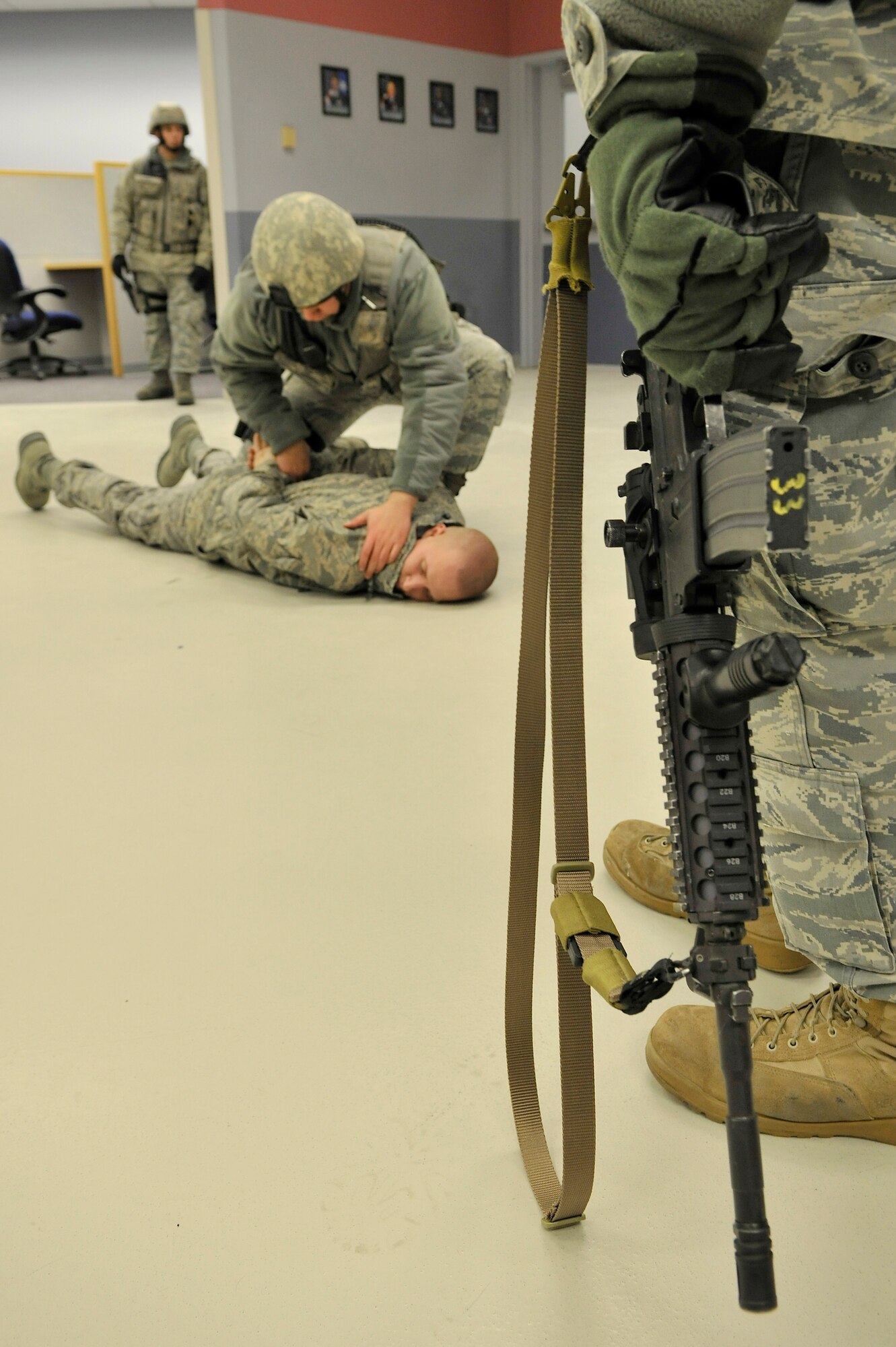 354th Security Forces Squadron members secure a suspect during an exercise scenario at the Joint Mobility Center Jan. 11, 2010, Eielson Air Force Base, Alaska. The scenario tested the SFS members ability to safely take control of the situation. (U.S. Air Force photo/Staff Sgt. Christopher Boitz)
