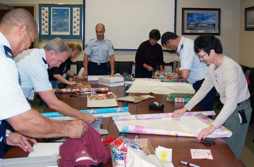 Members of the 505th Training Squadron finish wrapping gifts for the Hurlburt Field Angel Tree Program. Organizers said the booster club and the C2 Warrior Fund raised more than $4,000 intended for presents and clothes for 71 children at both Hurlburt Field and Eglin Air Force Base. (Courtesy photo)