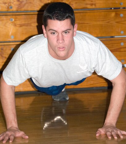 Airman 1st Class Robert Greene performs a set of pushups during a dodgeball game at the Fitness and Sports Center here Jan. 11. As part of the game, Airmen were required to perform a set of pushups each time they were hit by the ball. Airman Greene is a student at the First Term Airmen Center. (U.S. Air Force photo/Staff Sgt. Daniel Bowles)