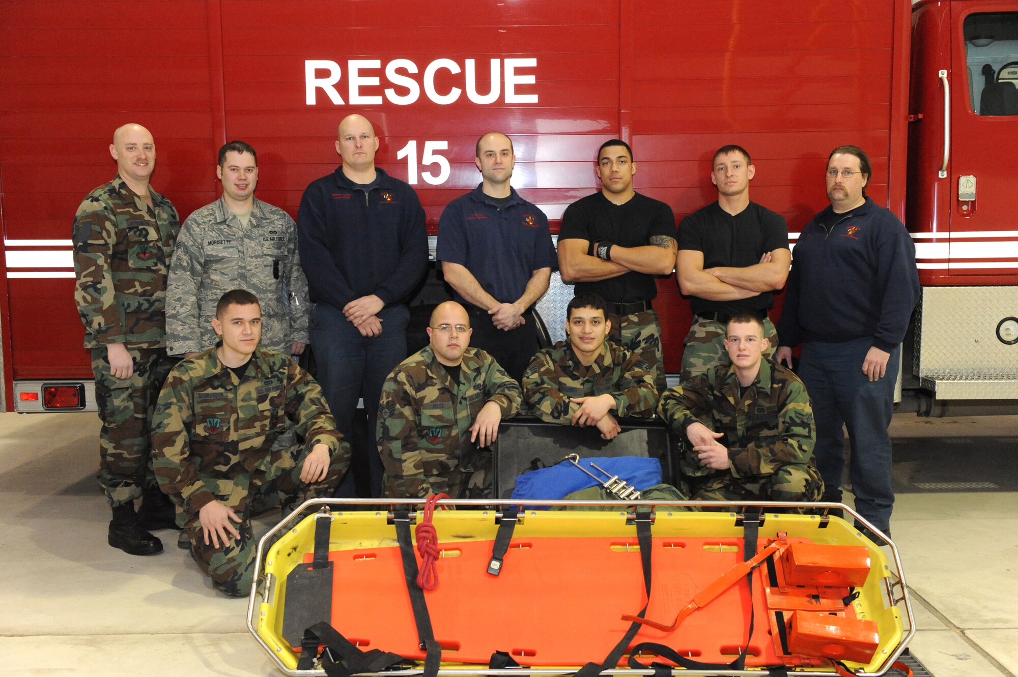 MINOT AIR FORCE BASE, N.D. -- Fire fighters from the 5th Civil Engineer Squadron pose for a photo here Jan 12. These 11 fire fighters responded to a call involving an individual who had fallen approximately eight feet into an excavation site off of Glacier Drive in base housing. The fire fighters performed a daring rescue saving the life of a contractor. (U.S. Air Force photo by Senior Airman Jesse Lopez)