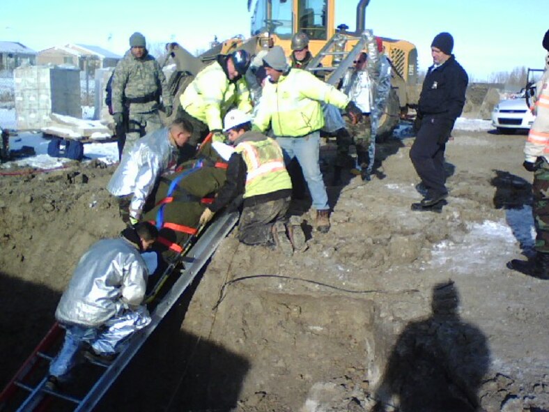 MINOT AIR FORCE BASE, N.D. -- Fire fighters from the 5th Civil Engineer Squadron pose for a photo here Jan 12. These 11 fire fighters responded to a call involving an individual who had fallen approximately eight feet into an excavation site off of Glacier Drive in base housing. The fire fighters performed a daring rescue saving the life of a contractor. (U.S. Air Force photo by Senior Airman Jesse Lopez)