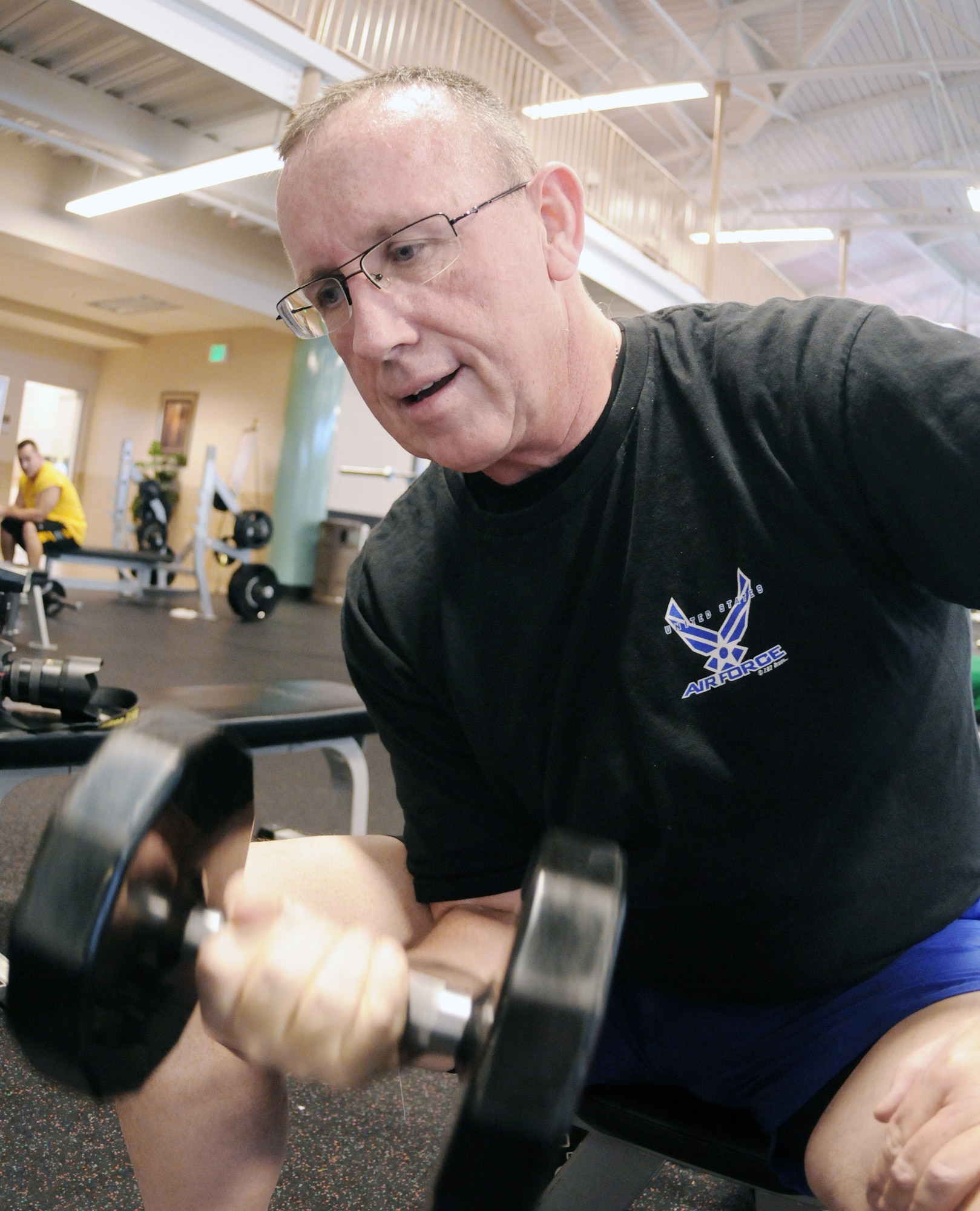 Mike Porter works out with weights Dec. 22, 2009, at the Rambler Fitness Center at Randolph Air Force Base, Texas. Mr. Porter shrunk from a peak of 334 pounds to 198 pounds following bariatric surgery and strict diet and exercise. Mr. Porter is the 12th Force Support Squadron assistant lodging manager. (U.S. Air Force photo/Don Lindsey)