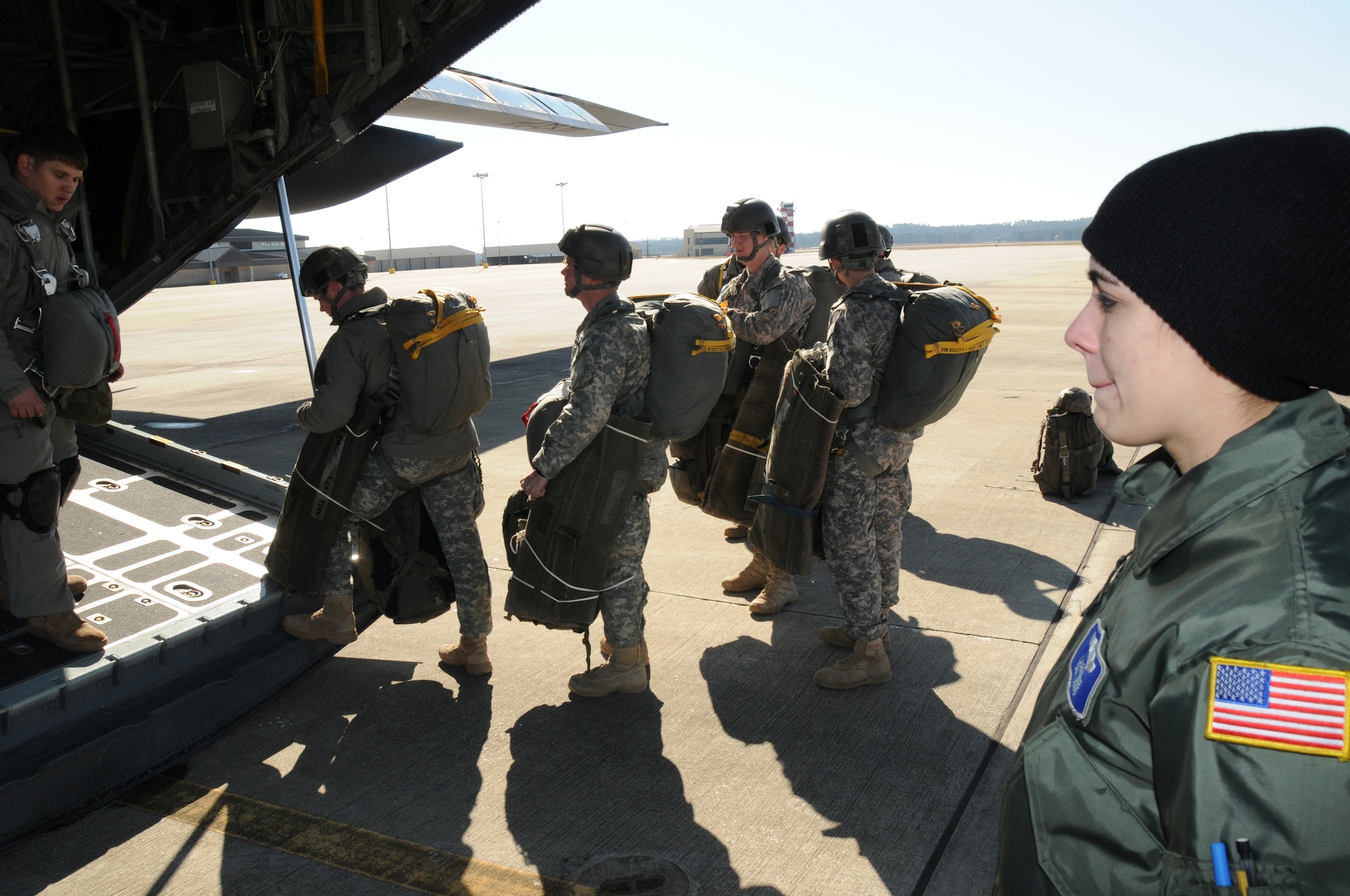 Load Master Senior Airman Laura Kruse observes the Army Rangers loading on the C-130. For the 107th Airlift Wing's first Army Ranger jump training operation. (AF Photo/Senior Master Sgt. Ray Lloyd)