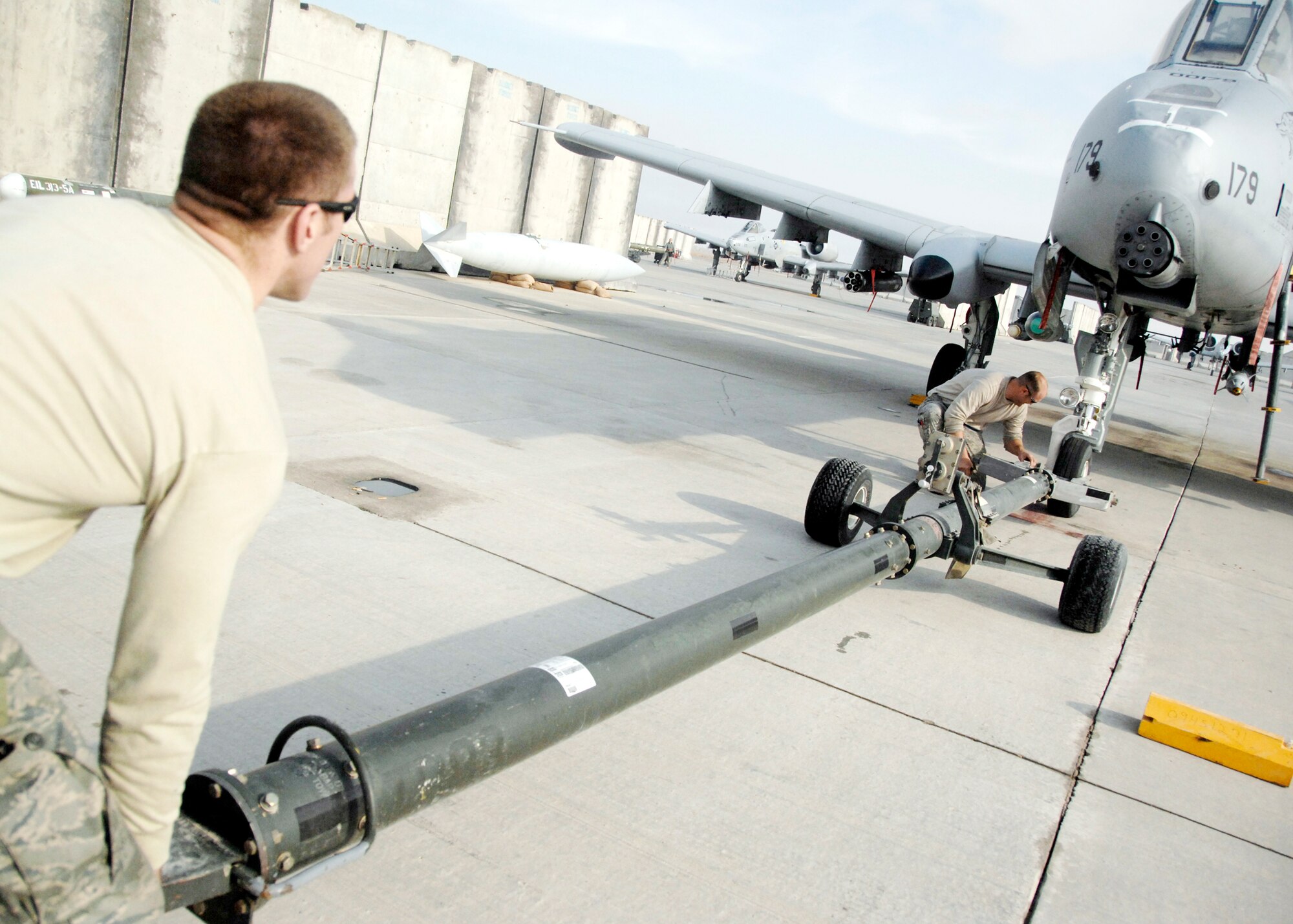 Senior Airman Nathan Tierney (left) and Staff Sgt. Eddie Evans return an aircraft after an in-flight emergency Dec. 10, 2009, at Kandahar Airfield, Afghanistan. Airman Tierney and Sergeant Evans are A-10 crash recovery technicians with the 451st Expeditionary Maintenance Squadron maintenance flight. (U.S. Air Force photo/Senior Airman Timothy Taylor)